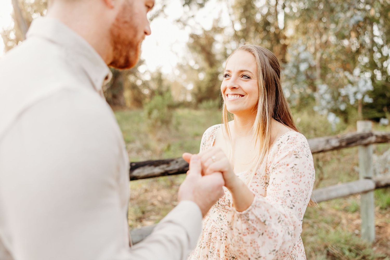Surprise proposal moment captured in golden afternoon light.