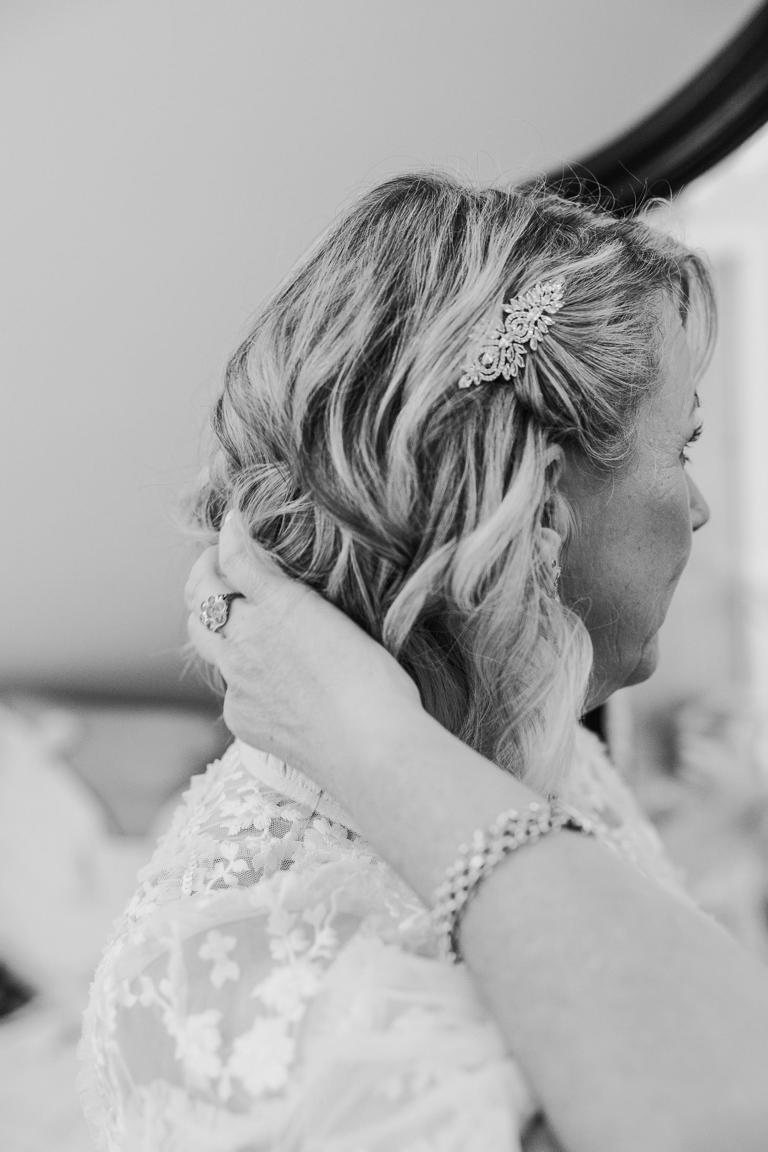 Delicate lace details and hair accessories being styled for a special occasion.