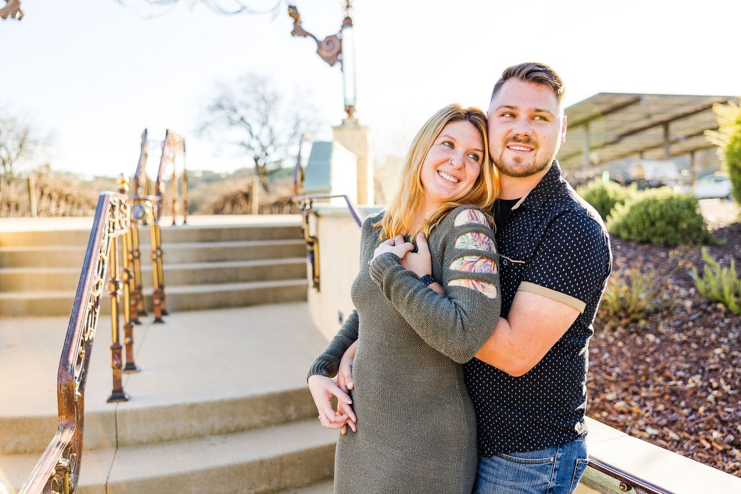 Romantic outdoor portrait on garden steps during golden hour.