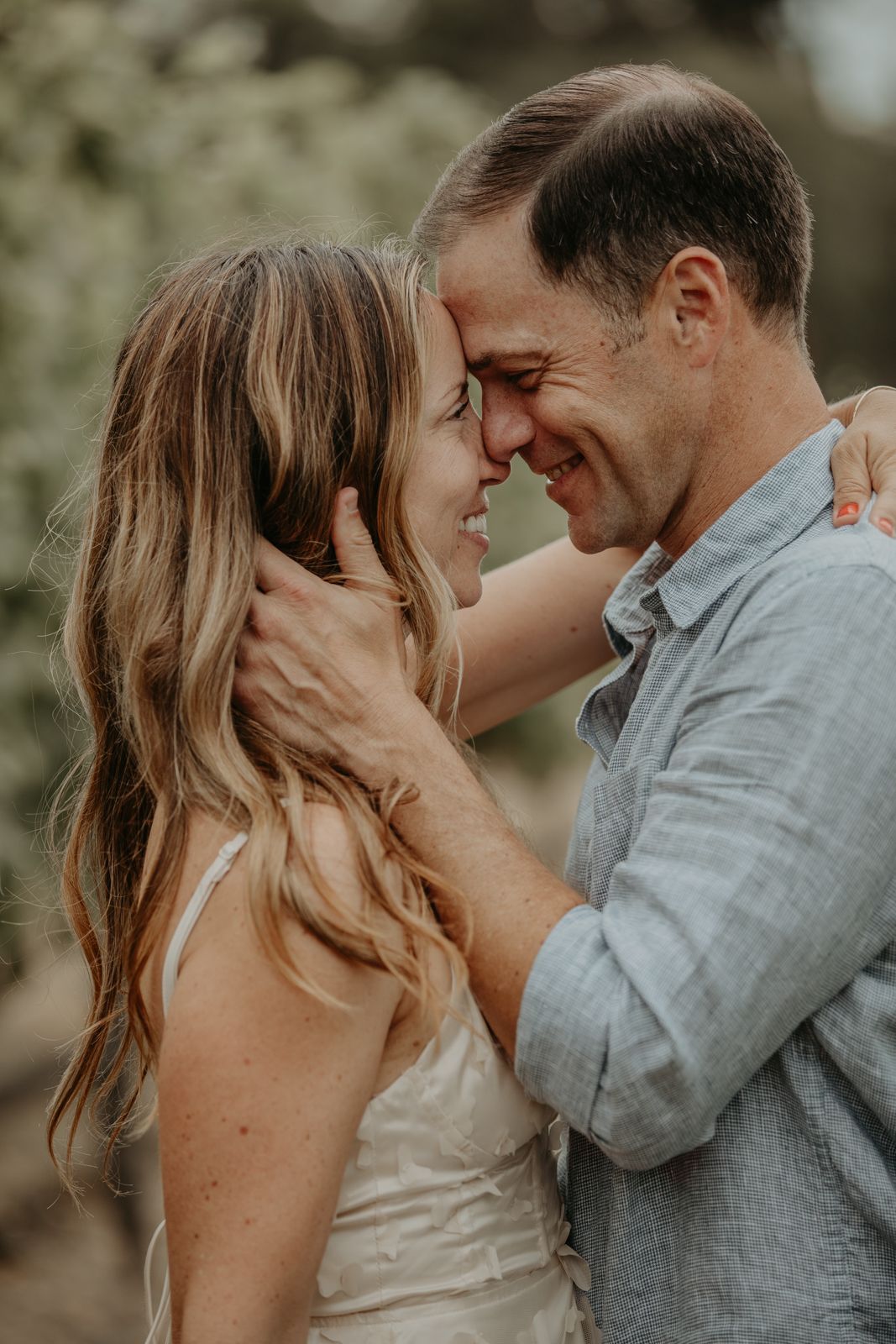 A romantic couple shares intimate moments in a series of tender embraces against a soft natural backdrop.