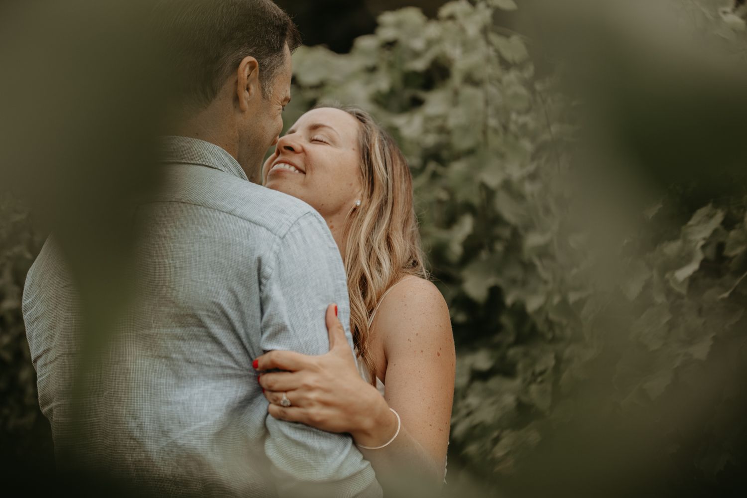 Romantic couple shares an intimate embrace during an outdoor wedding photoshoot.