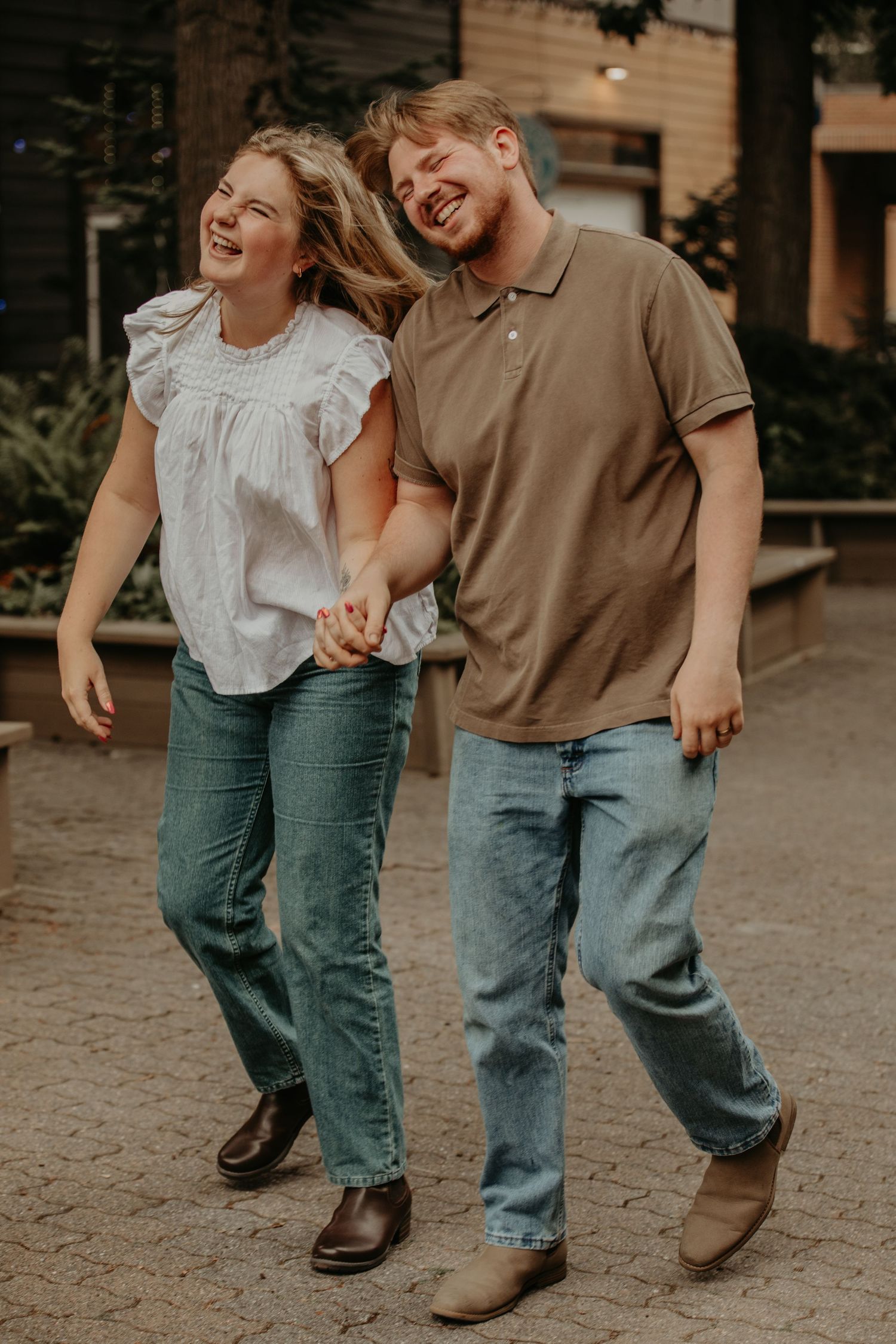 A series of legs with jeans and boots walking together outdoors showing laughter and joy in candid motion.