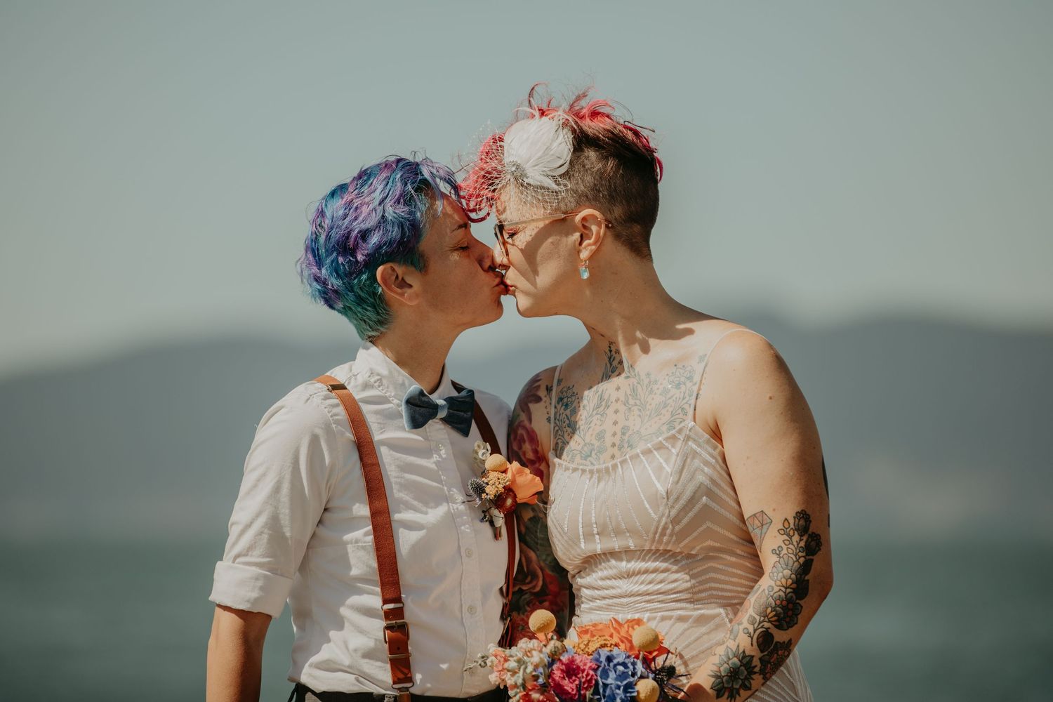 Couple shares intimate moments during their wedding photoshoot against a misty mountain backdrop.