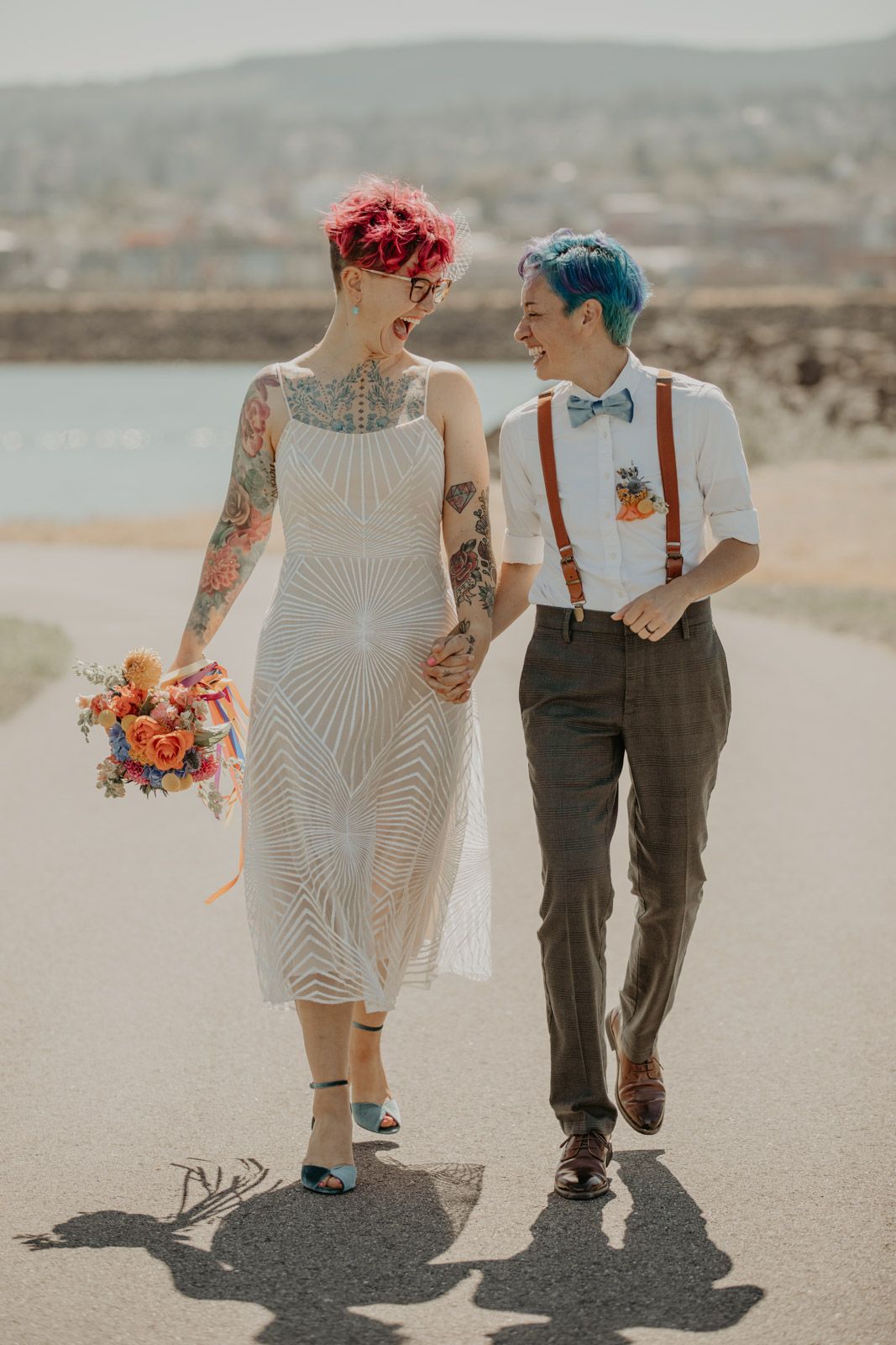 Couple walks together on desert path wearing vintage-inspired wedding attire.