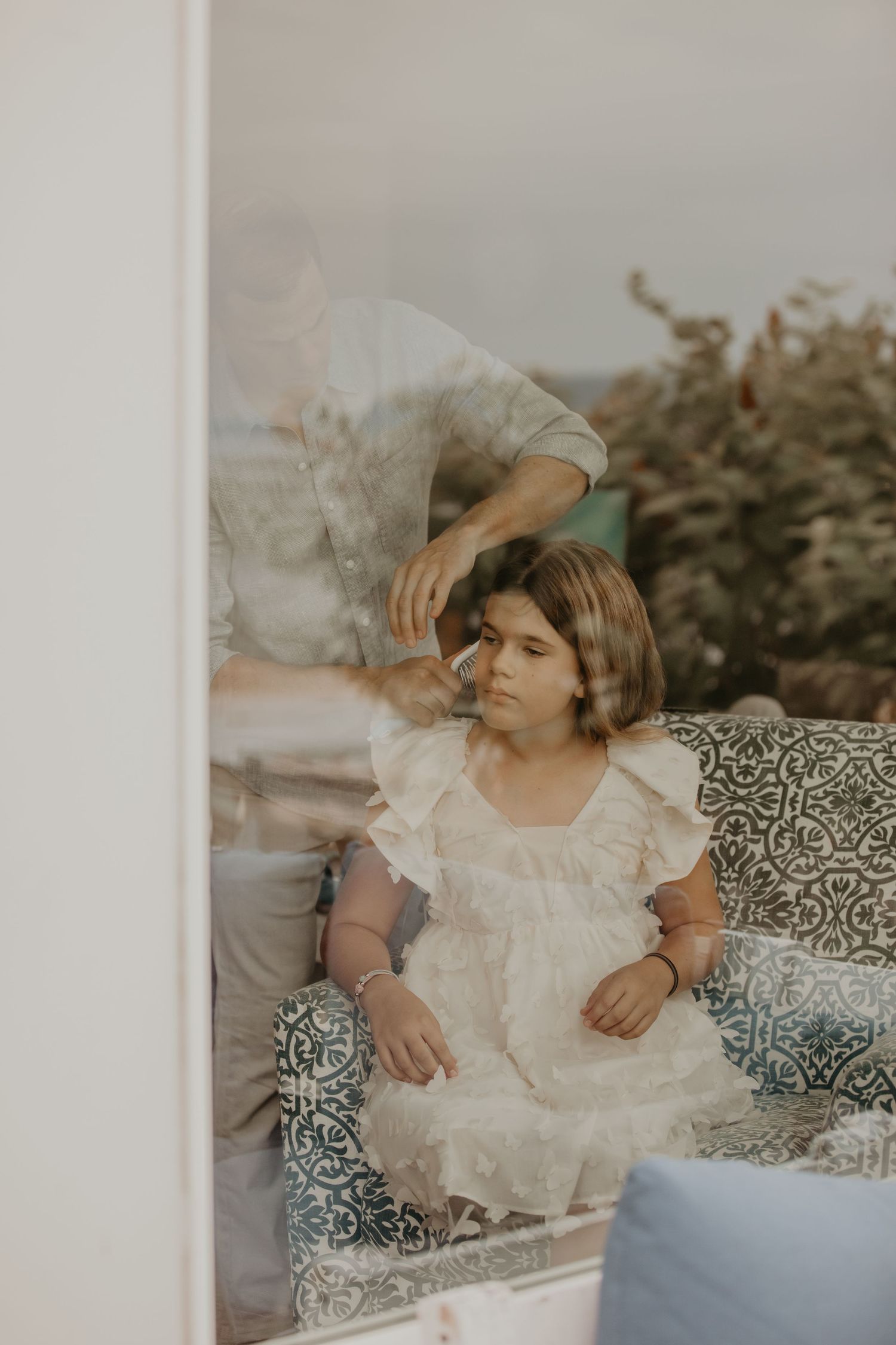 Artistic multiple exposure portrait showing movement and reflection in soft vintage tones.