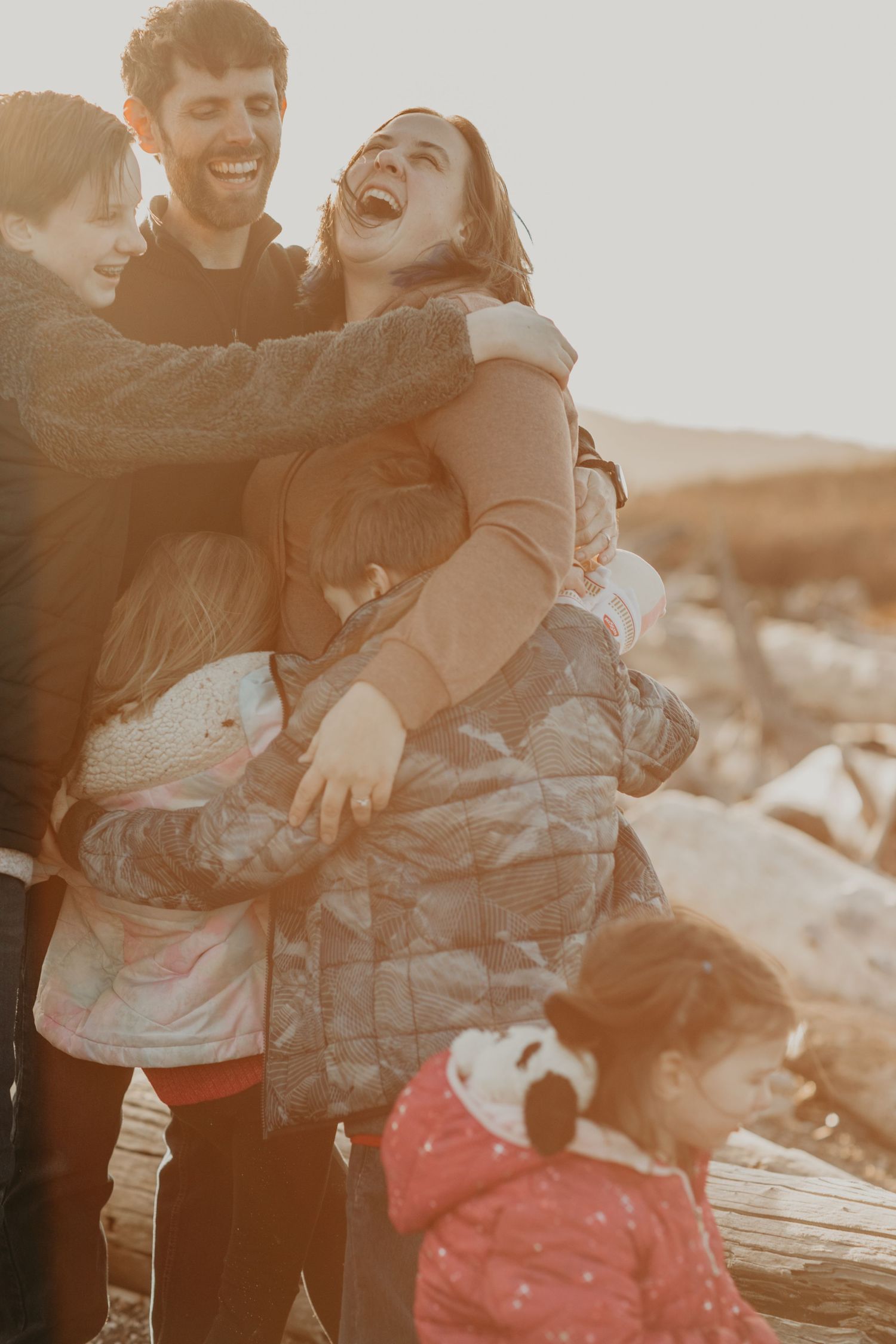 A candid sepia-toned photograph captures a joyful moment of shared laughter outdoors.