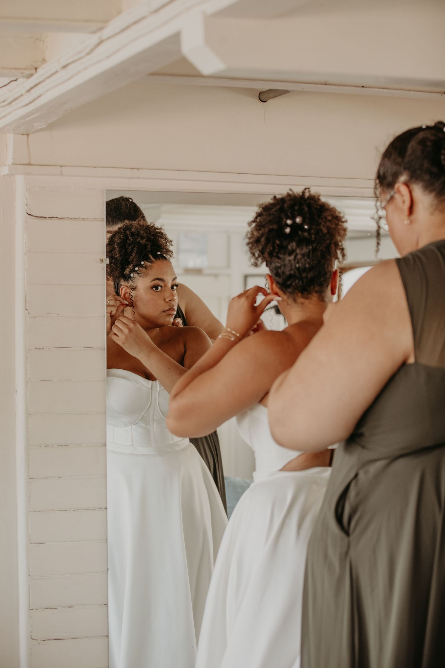 A sequence of intimate wedding moments captured in a white indoor setting.