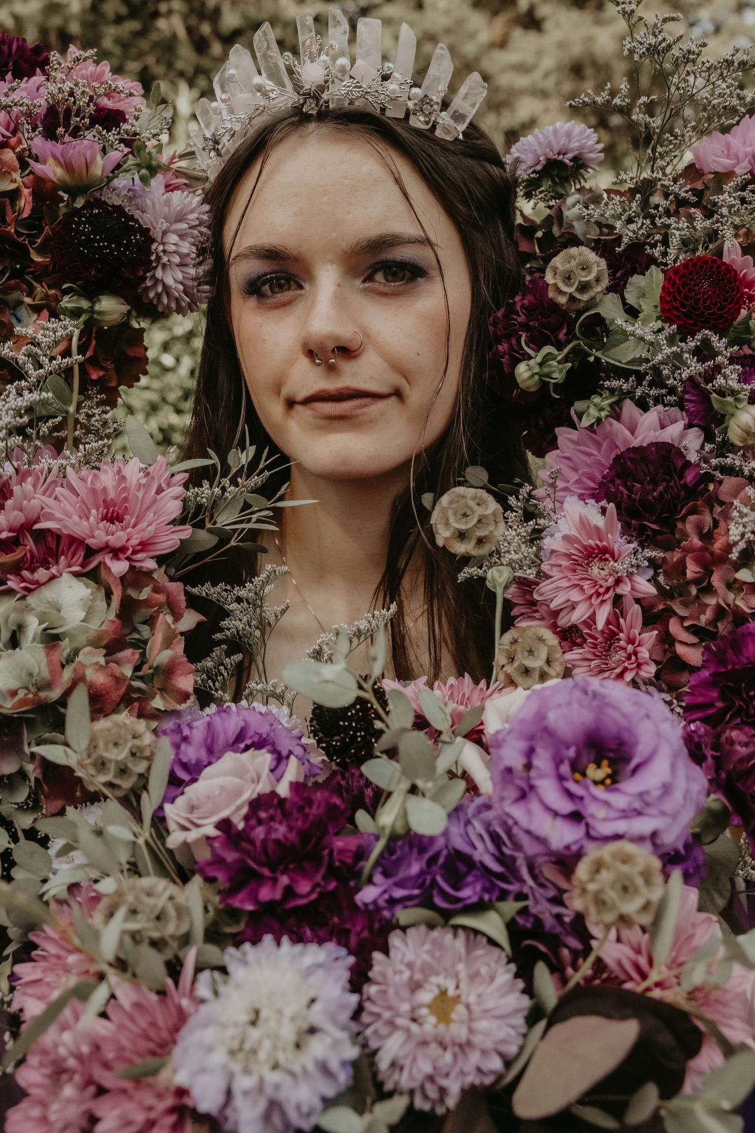 Romantic floral arrangement featuring pink and purple blooms with delicate petals in a vintage-inspired garden setting.