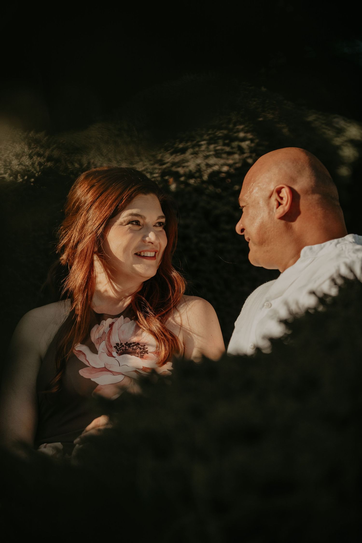 Moody artistic photo series showing tender moments between a couple in dramatic shadows and warm lighting.