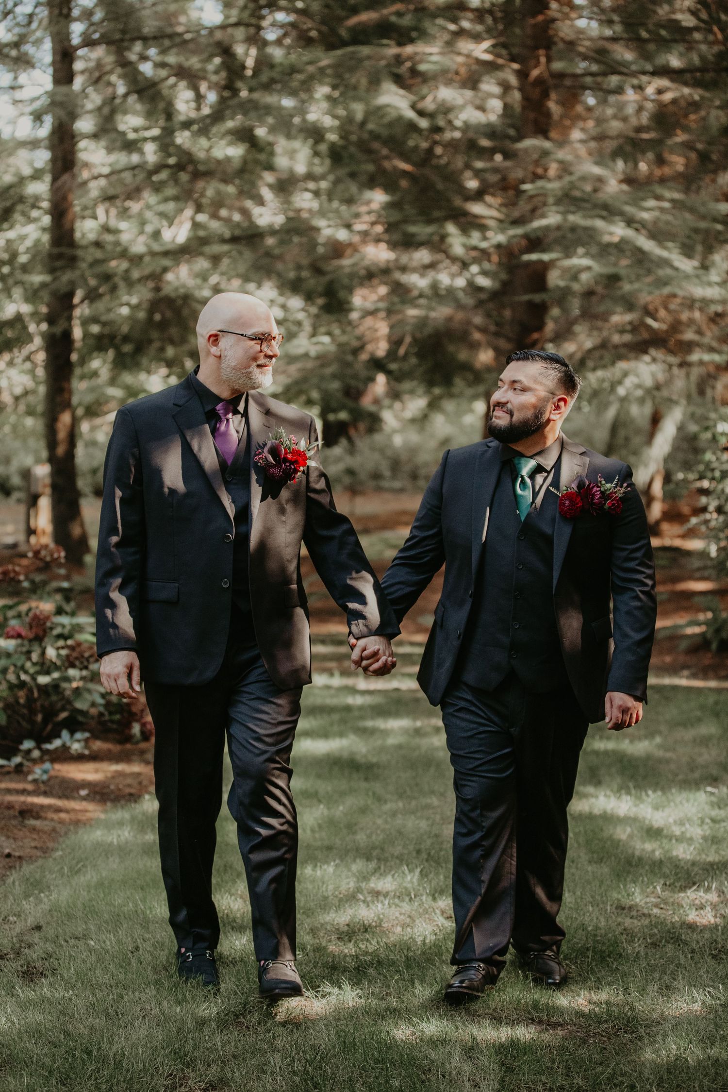 Four candid moments in a wooded outdoor setting showing people in black suits sharing joyful interactions.