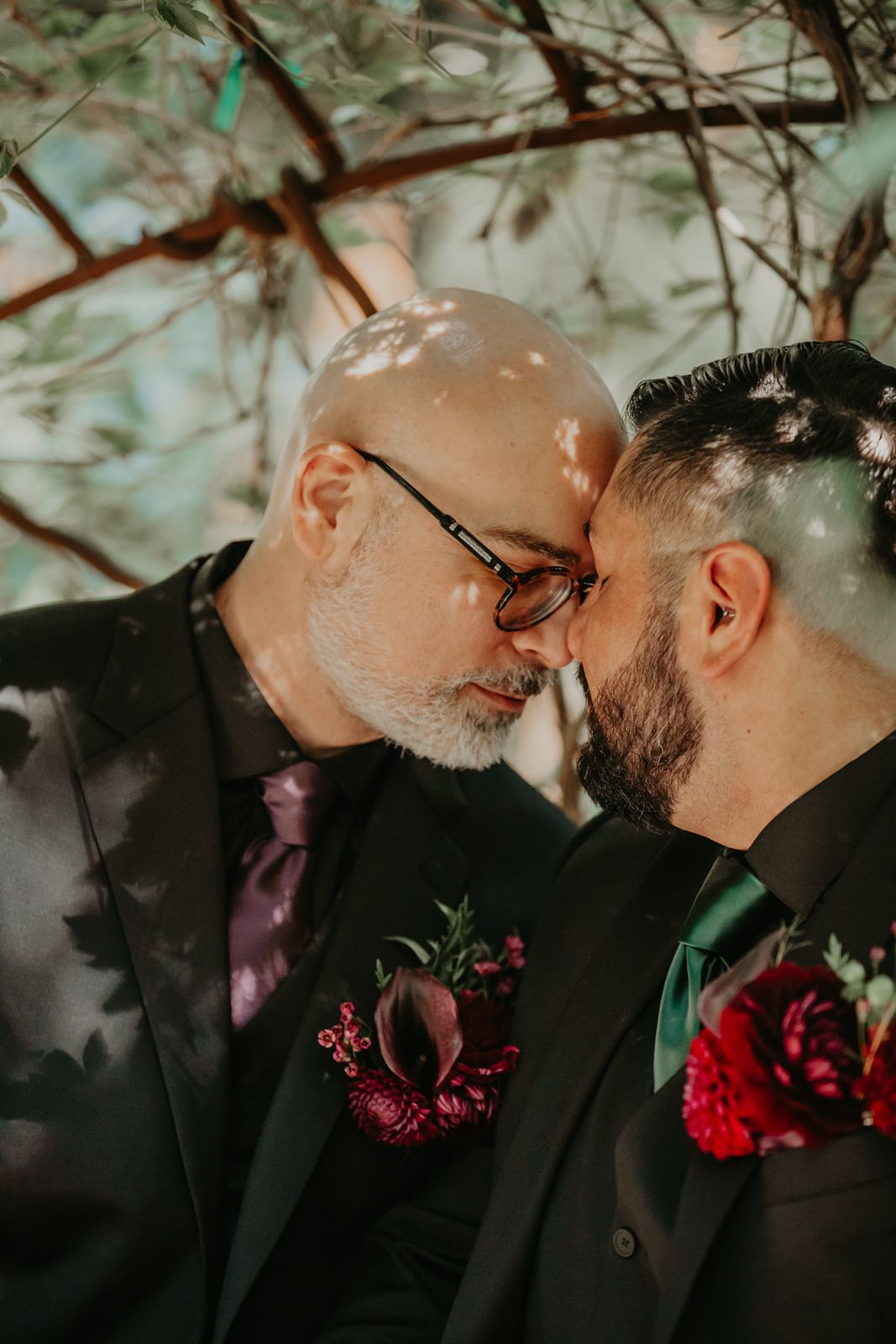 A romantic wedding moment captured in a series of four intimate photos with burgundy floral boutonnieres and black suits.