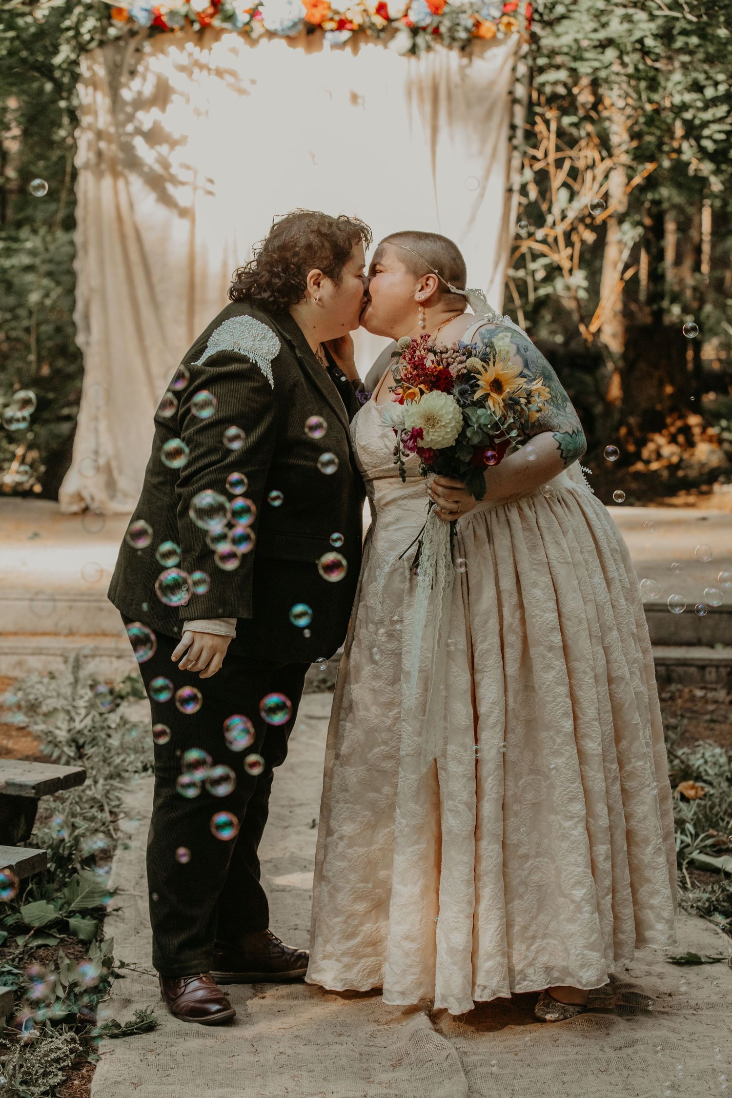 A romantic wedding photo series with soap bubbles floating through the air as a couple shares intimate moments in nature.