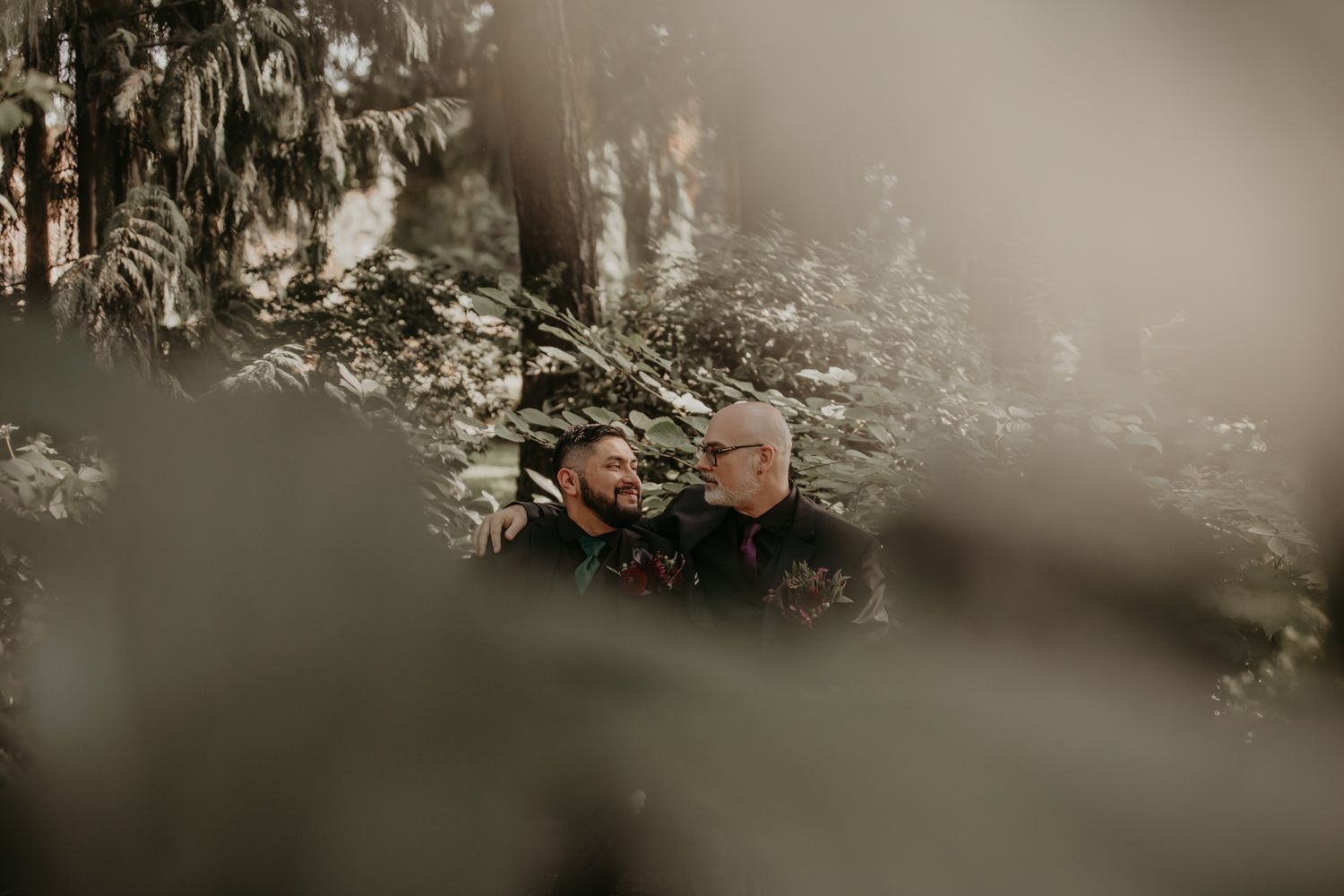 A vintage car drives through a misty forest road with soft, dreamy lighting creating an ethereal atmosphere.