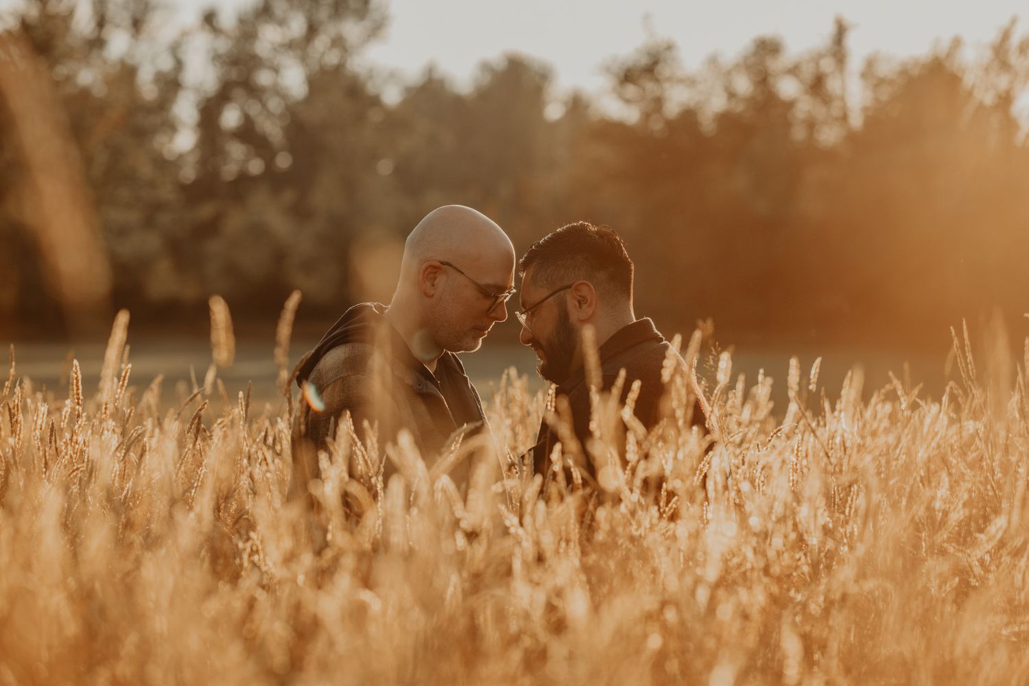 Seattle engagement photographers capture serene couple in a field of long grass.
