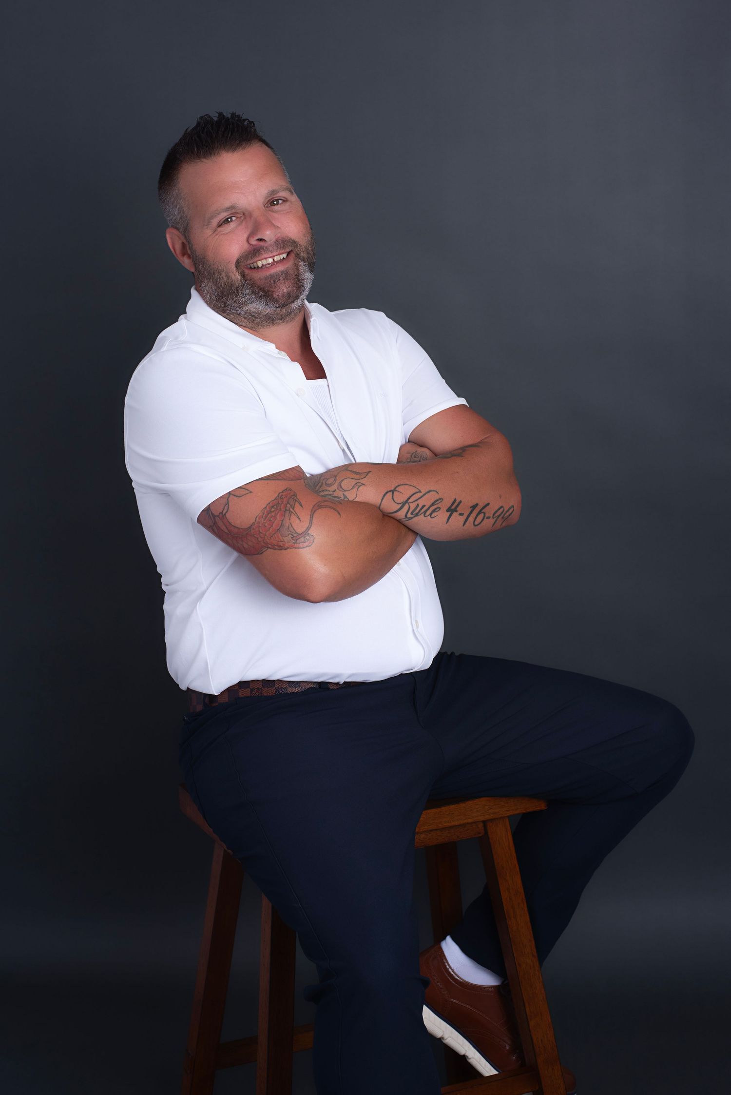 A series of professional studio portraits showing someone seated on a wooden stool against a dark background.