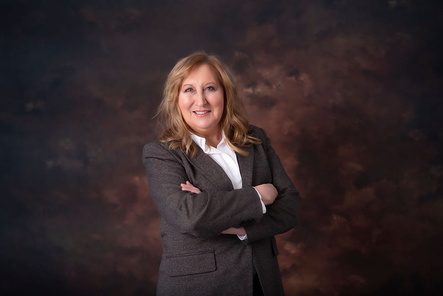 Professional portrait photos in formal business attire against a dark background with dramatic lighting.