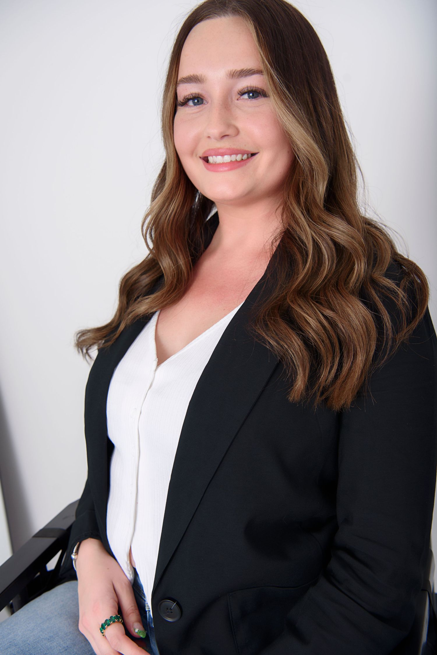 Professional headshot series showing a woman in a black blazer and white top against a light background.