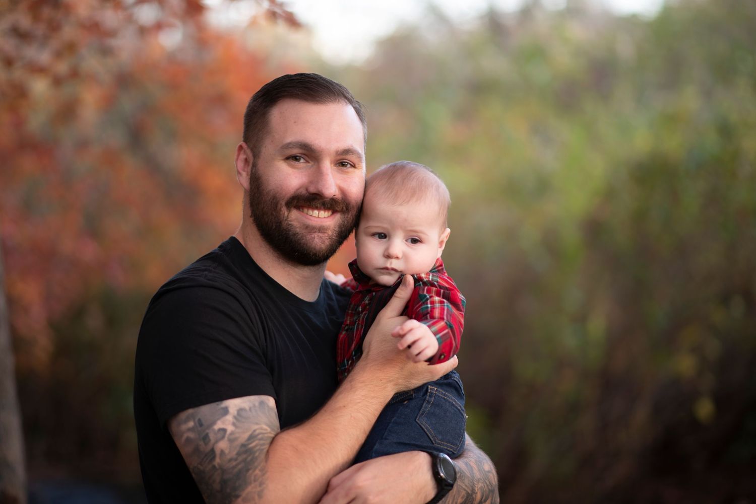 Heartwarming outdoor portrait series showing playful interactions between adult and infant against fall foliage.