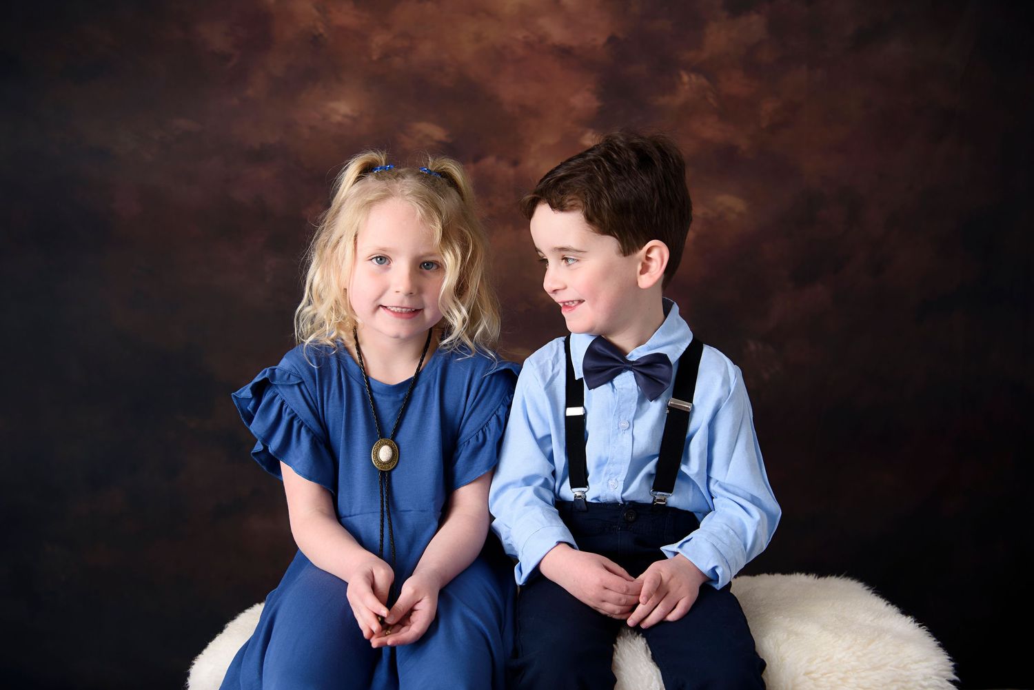 A heartwarming collection of family photos showing people in coordinating blue outfits against a dark backdrop.