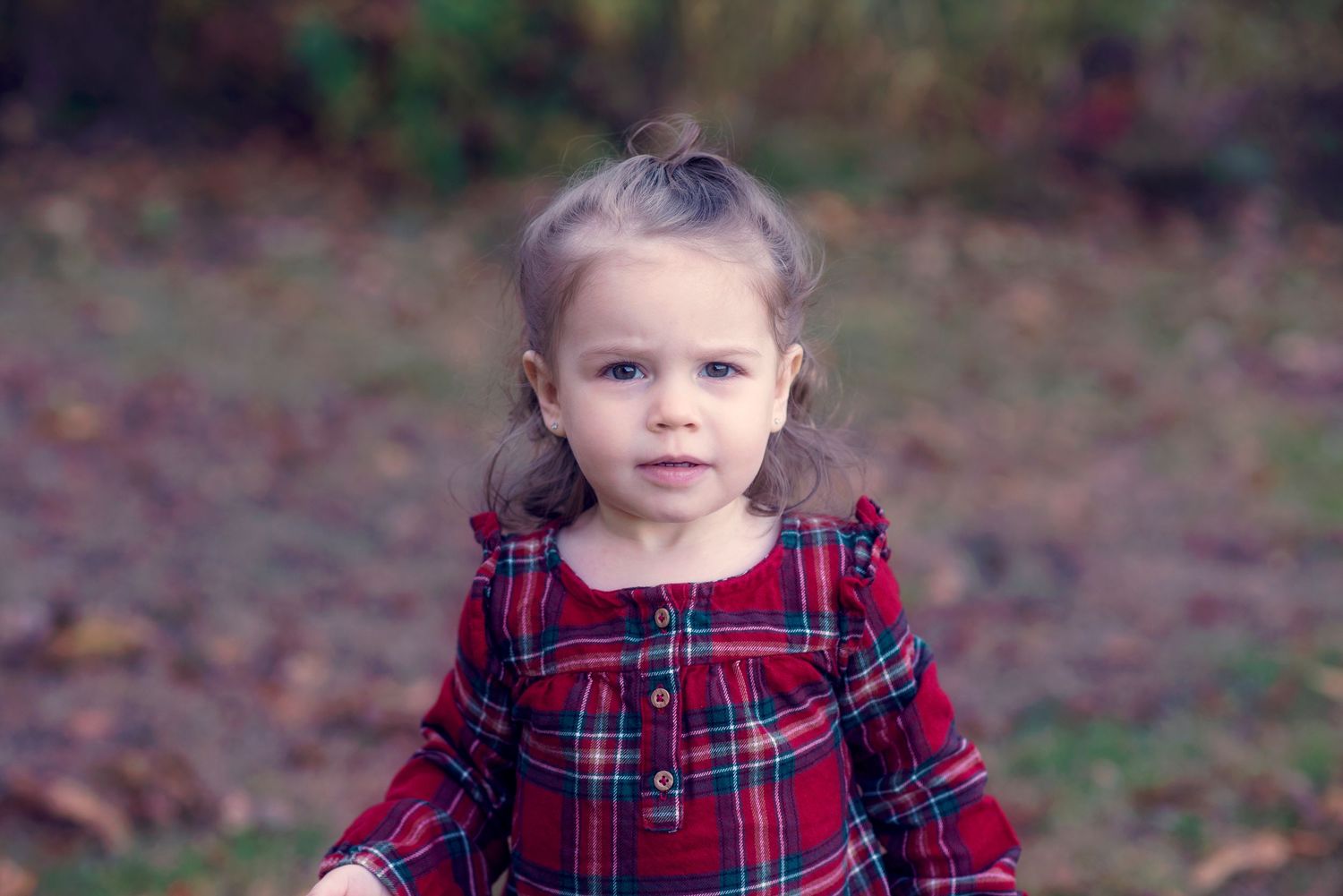 A sequence of photos shows a child in a red plaid dress twirling and dancing outdoors in an autumn setting.