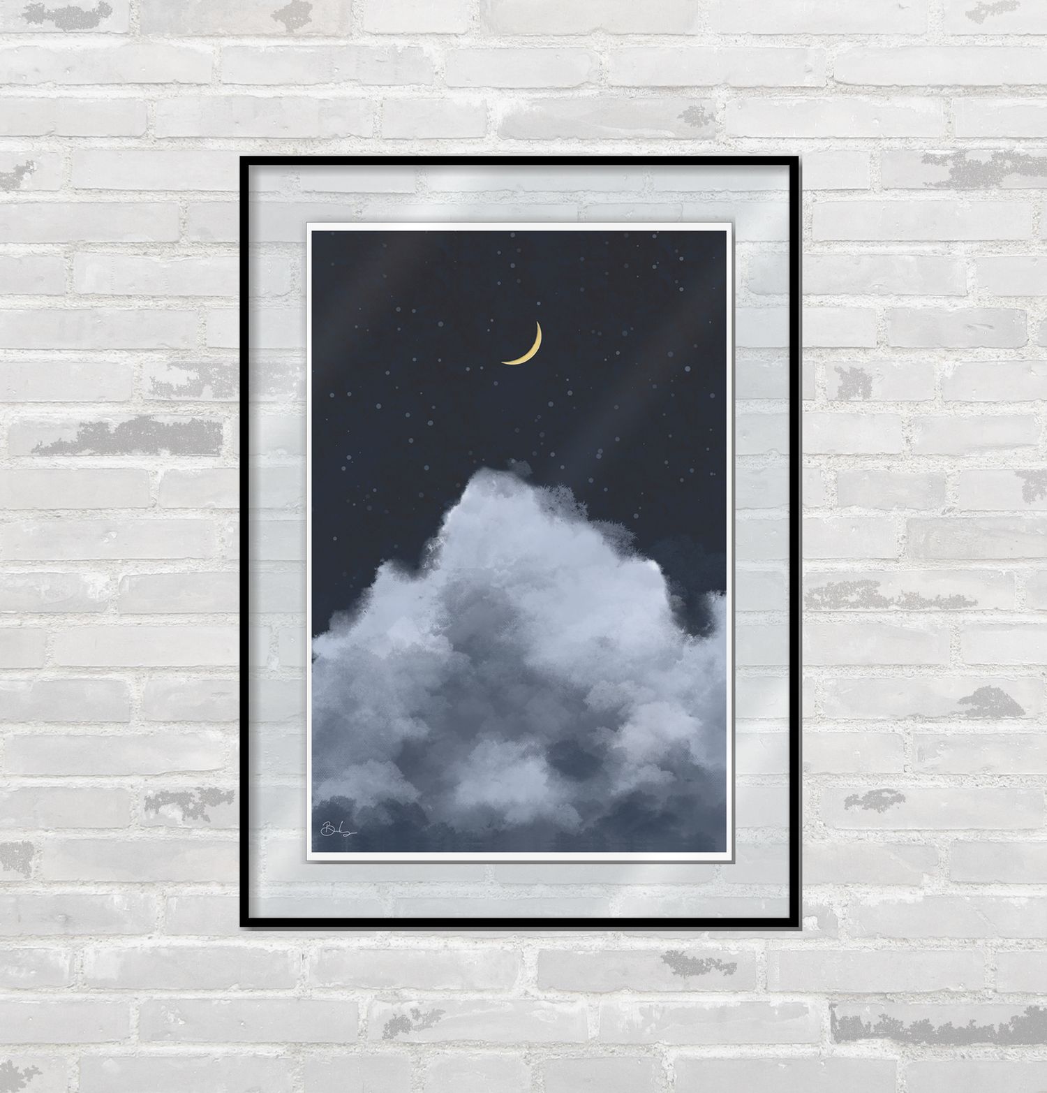 Framed art print depicting a night sky with clouds and a crescent moon hanging on a white brick wall.