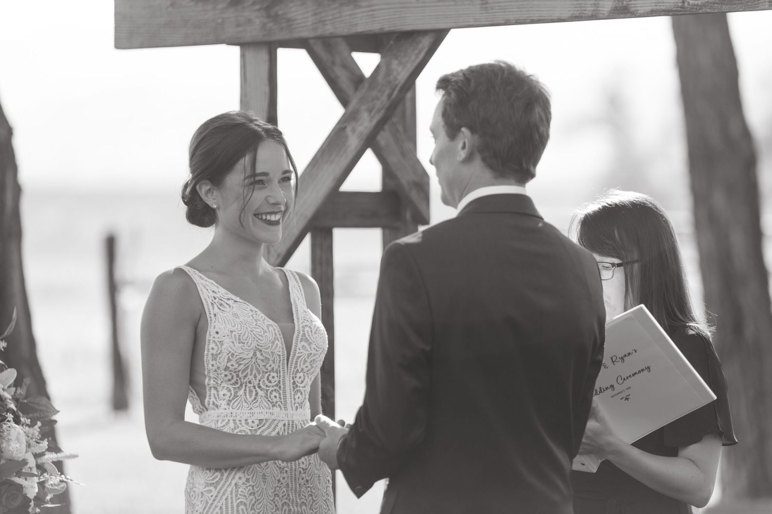 Candid black and white wedding moments captured during an outdoor ceremony.