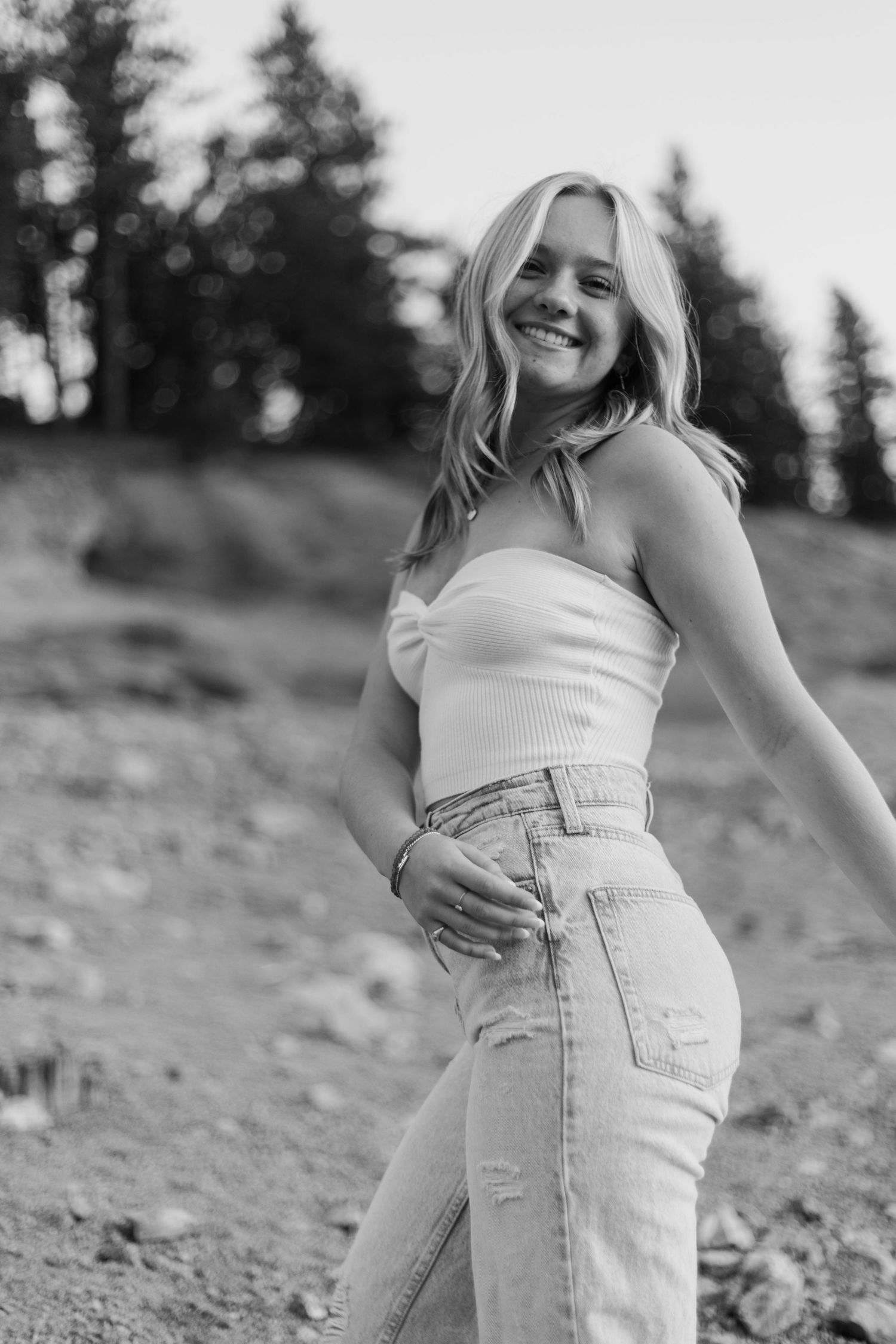 Black and white portraits showing playful poses against a natural mountain backdrop.