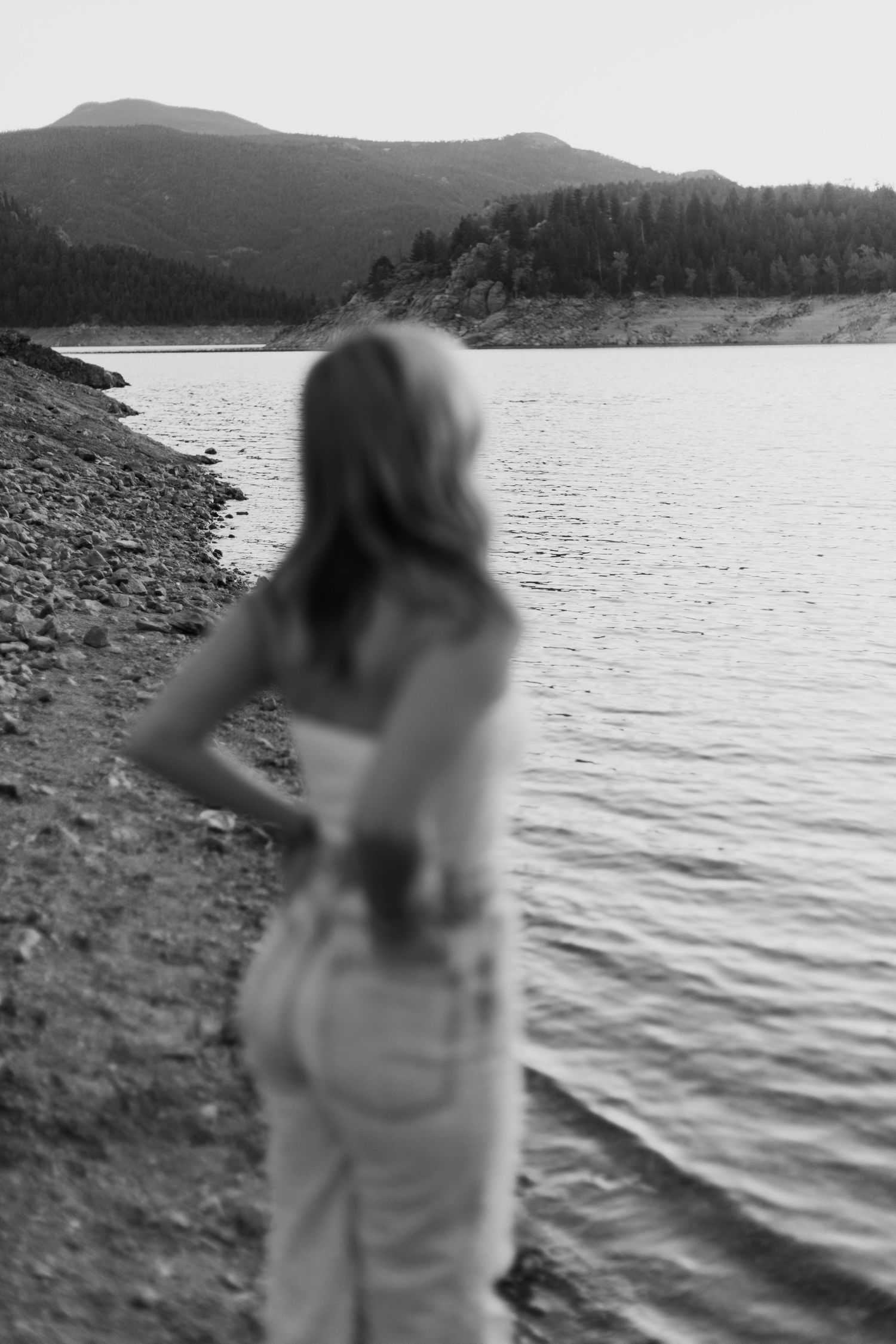 Black and white lakeside portraits with mountains and water in the background.