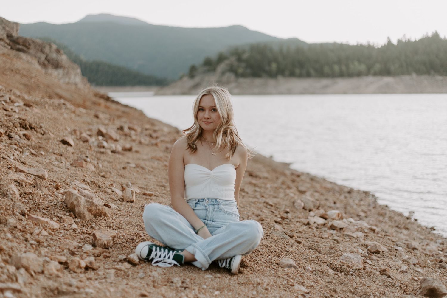 Series of outdoor photos by a lake showing poses on rocky terrain.