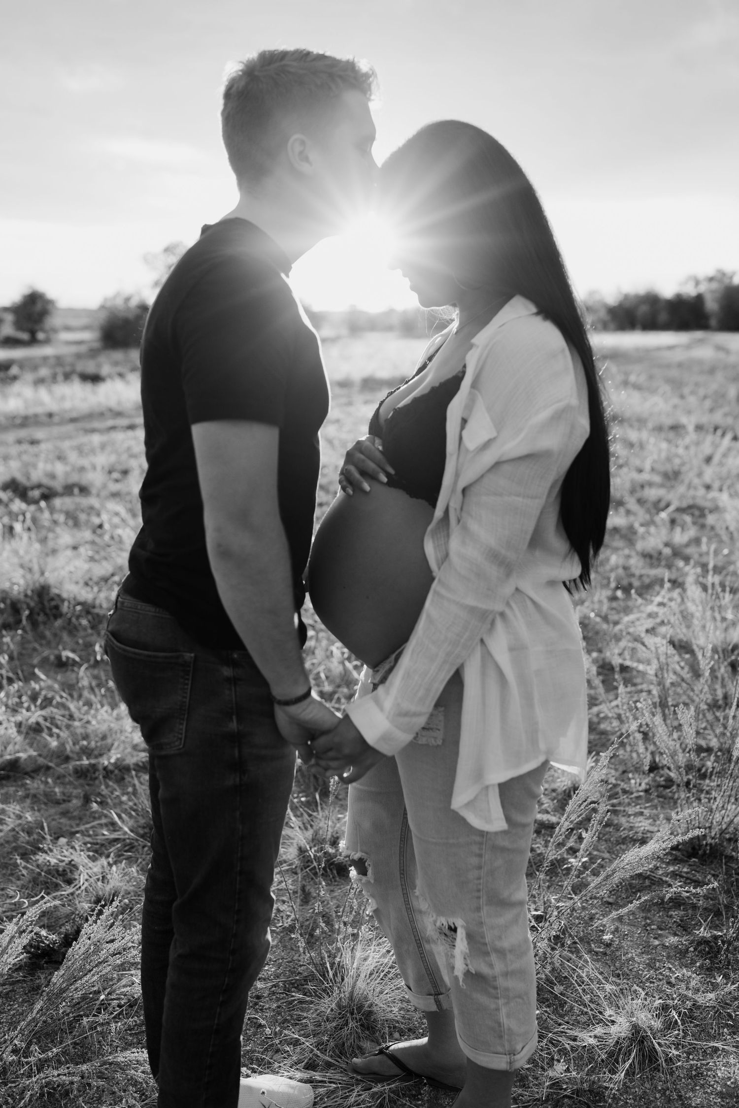 Series of black and white photos showing tender moments between a couple in nature.