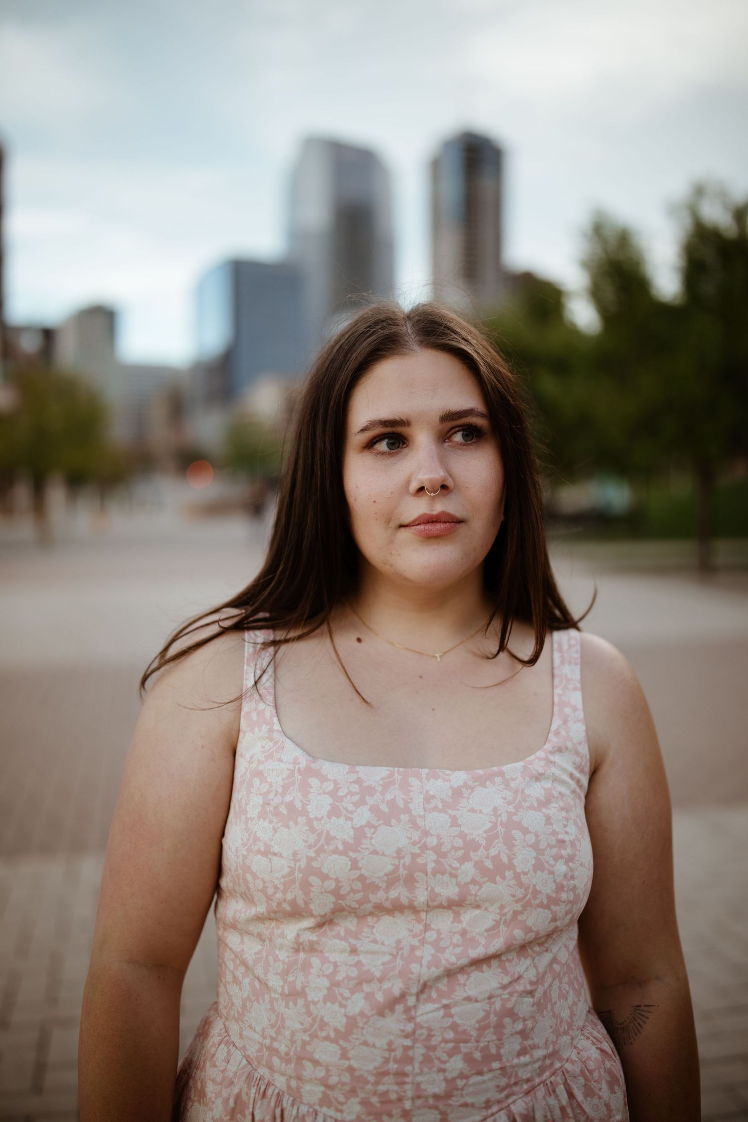 Urban portrait with downtown skyline and buildings in soft focus background.