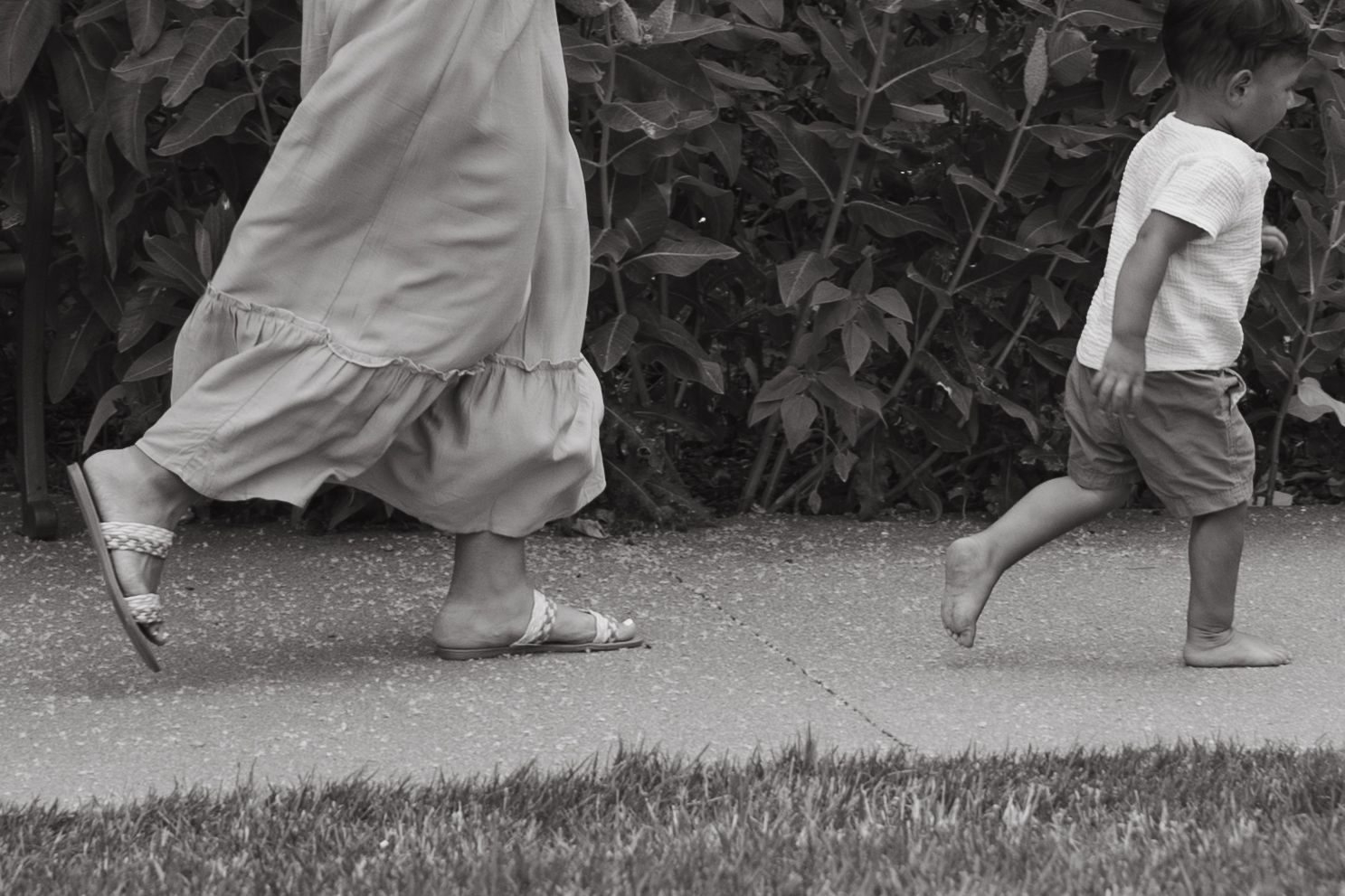 Black and white photo showing movement of flowing dresses and dancing feet.