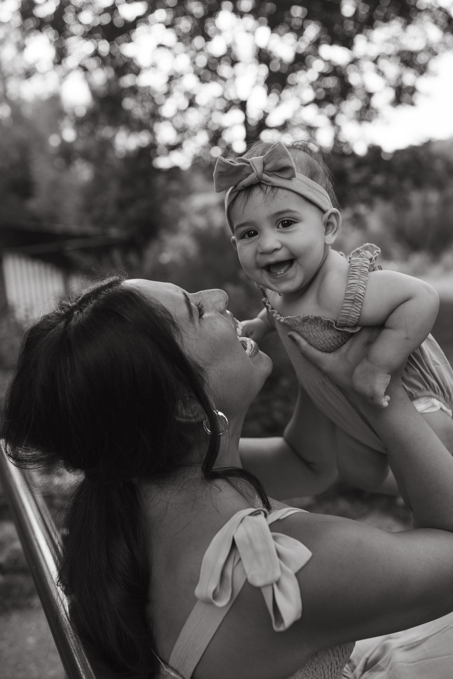 Black and white portrait capturing tender moment between parent and child.