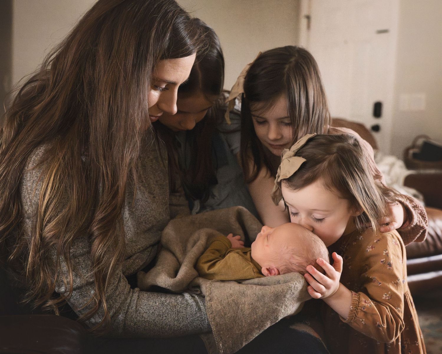 Warm family moment captured indoors as siblings gather close together.
