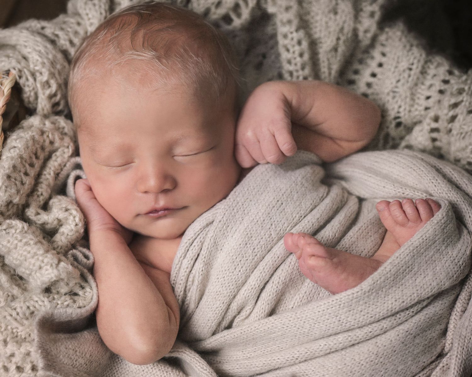 A collage of serene newborn baby photography with soft gray wraps and delicate poses on neutral backgrounds.