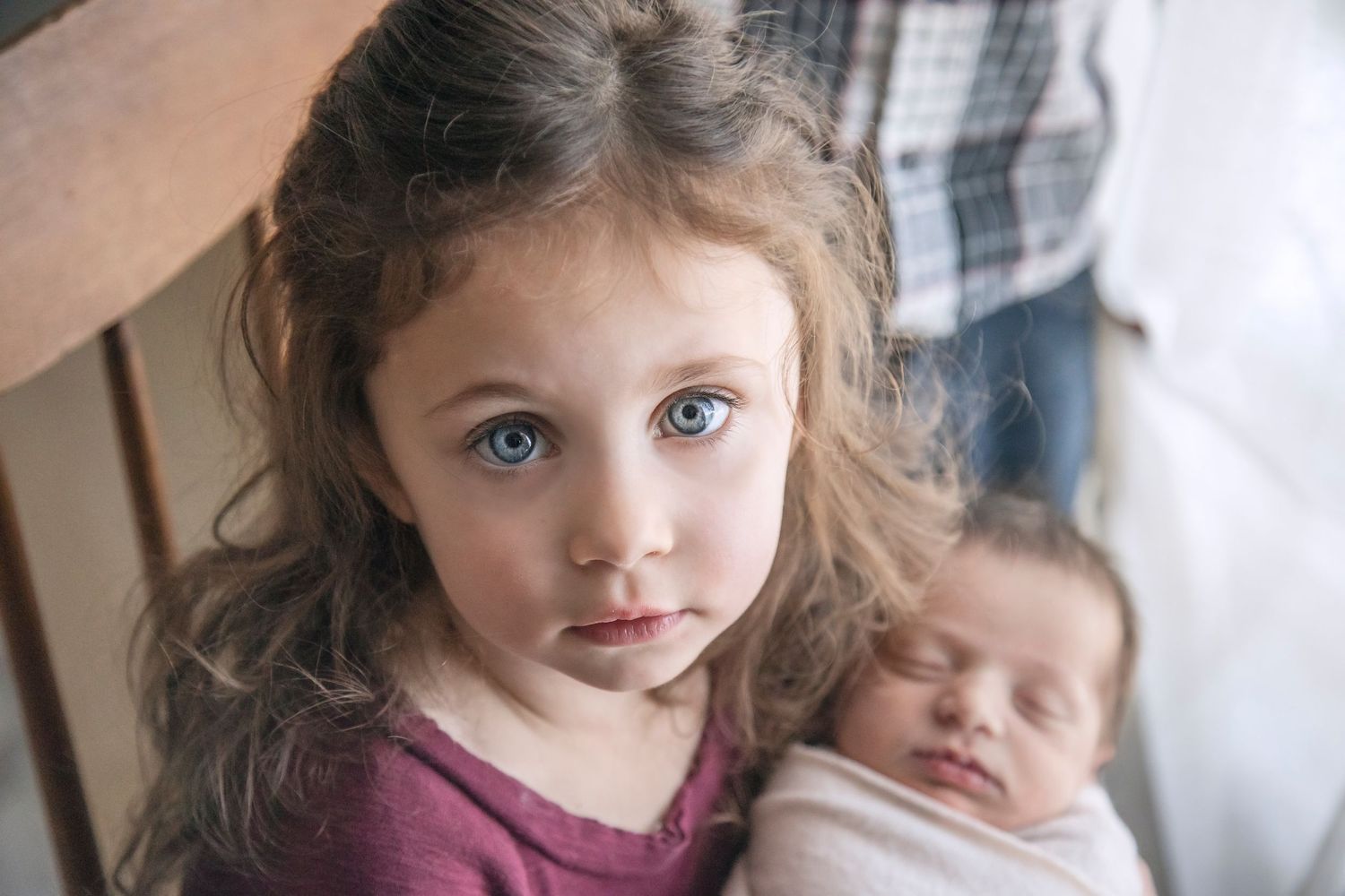 A heartwarming sibling moment with a newborn baby.