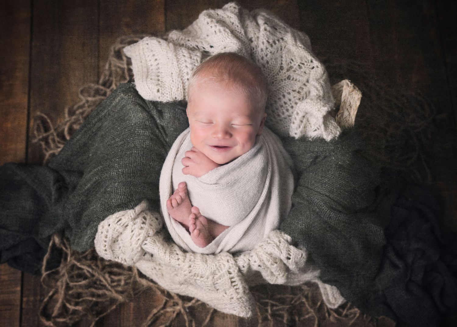 Newborn baby swaddled in white lace blanket lies on dark textured background in professional photo collage.
