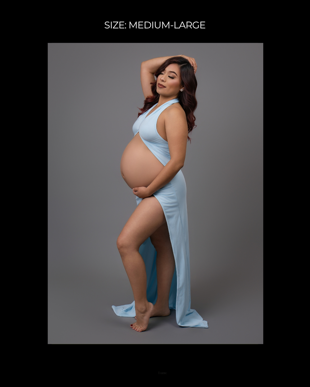 Pregnant woman in light blue halter maternity gown with thigh slit, size medium-large, posing in professional studio.