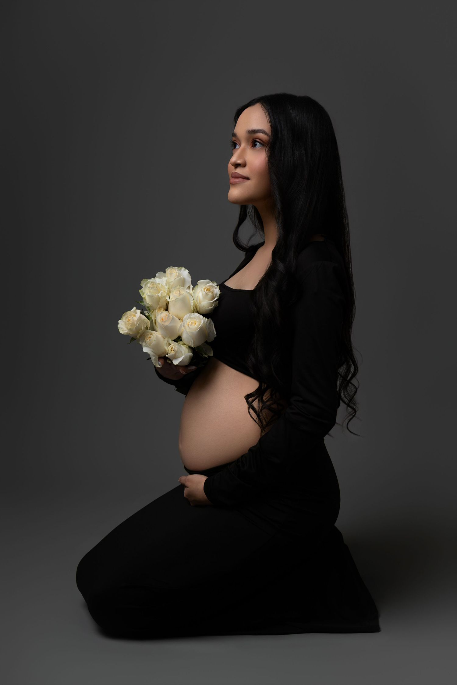 A series of moody portraits showing a figure in black holding white roses against a dark gray backdrop.
