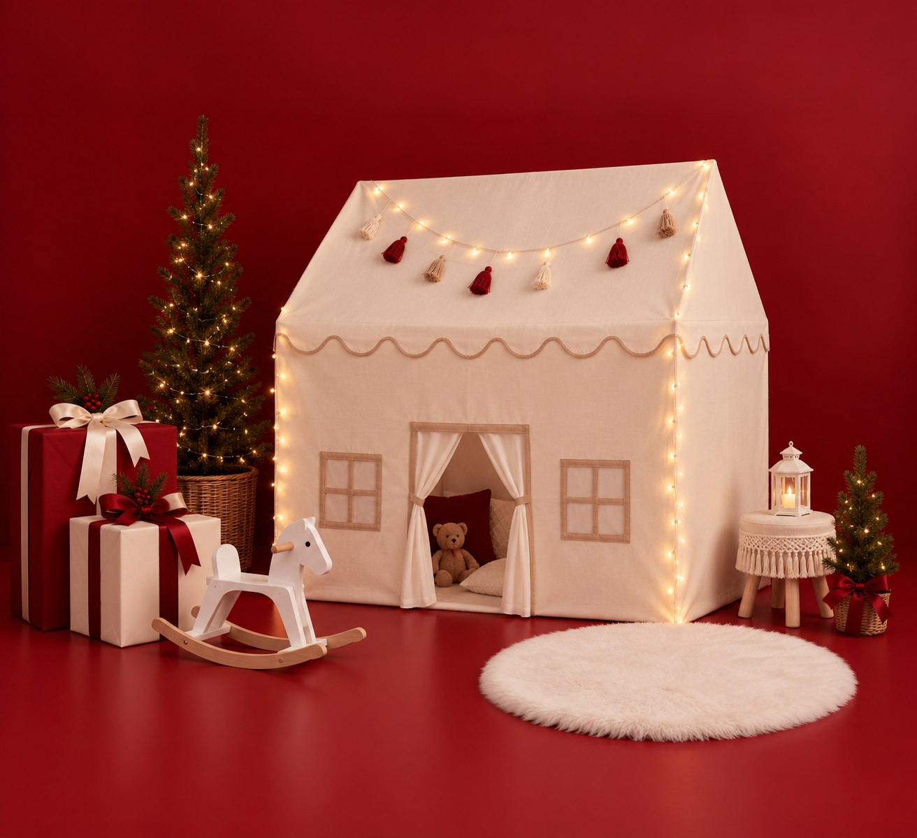 Cozy cream play tent with fairy lights, rocking horse, teddy bear, and Christmas trees on red background.