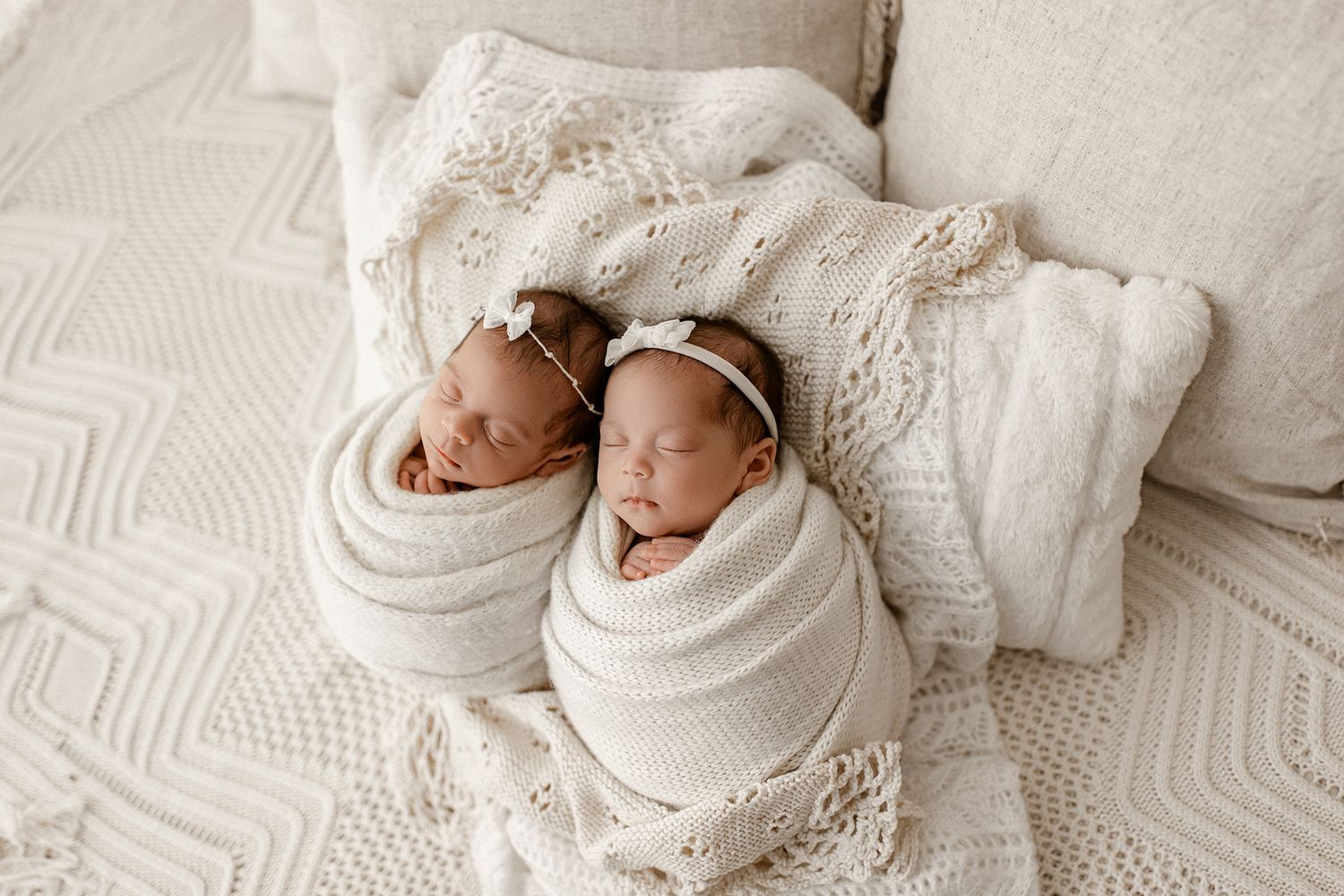Five connected photos show a sleeping newborn baby swaddled in white blankets during a professional photoshoot.