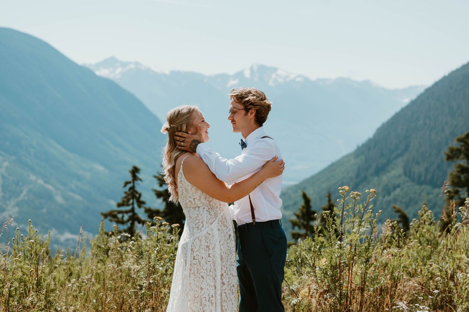A romantic wedding moment captured against a backdrop of majestic mountain peaks.