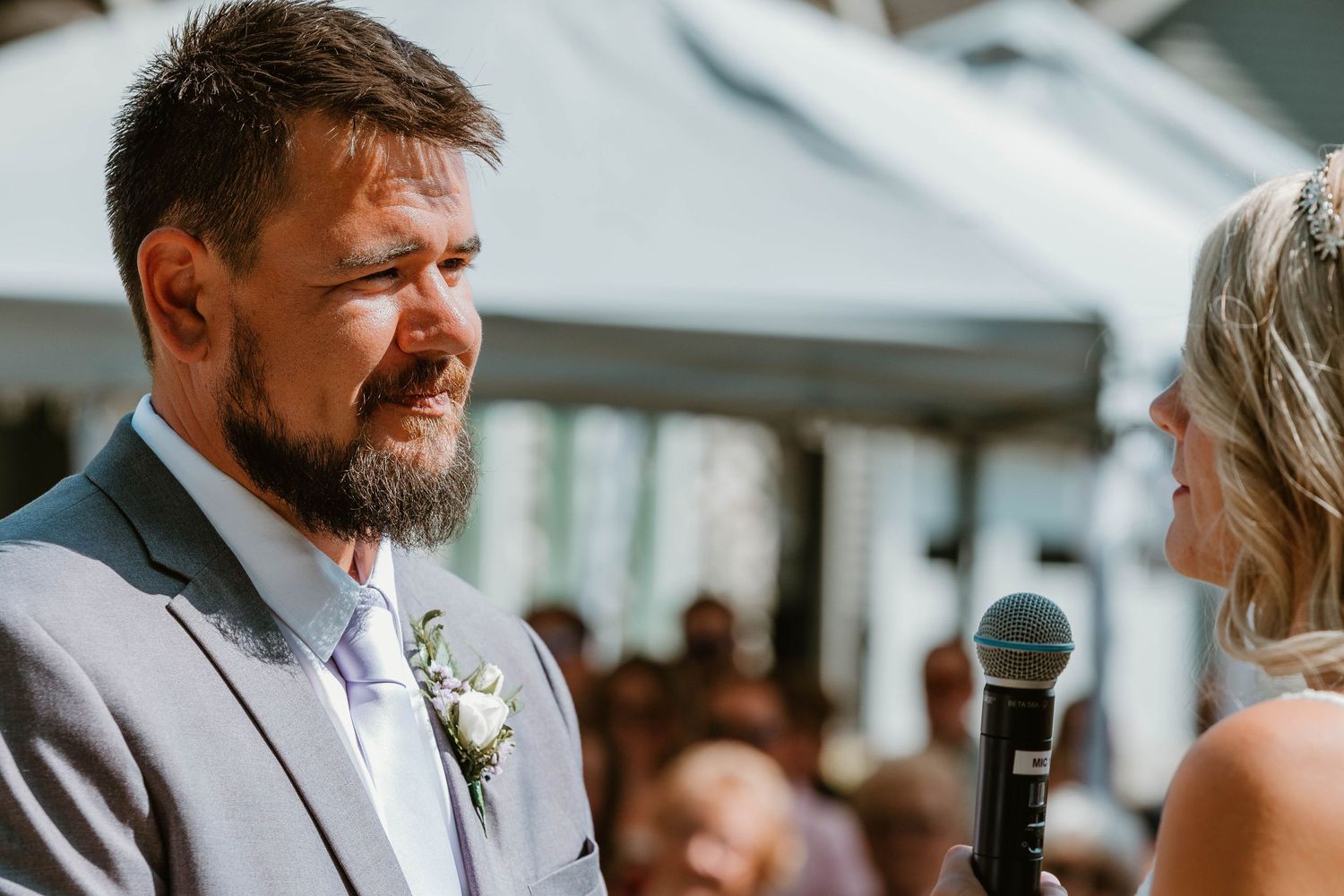 Emotional moment during wedding ceremony vows at outdoor venue.