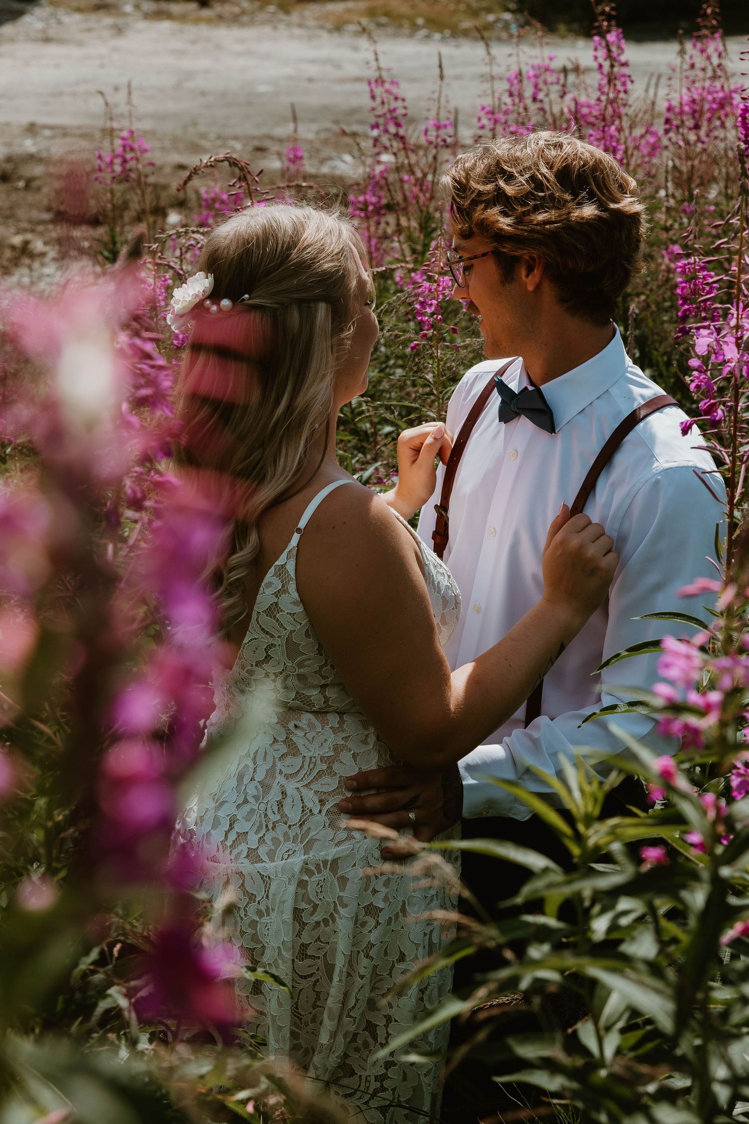 A romantic moment among purple wildflowers on a mountain trail.