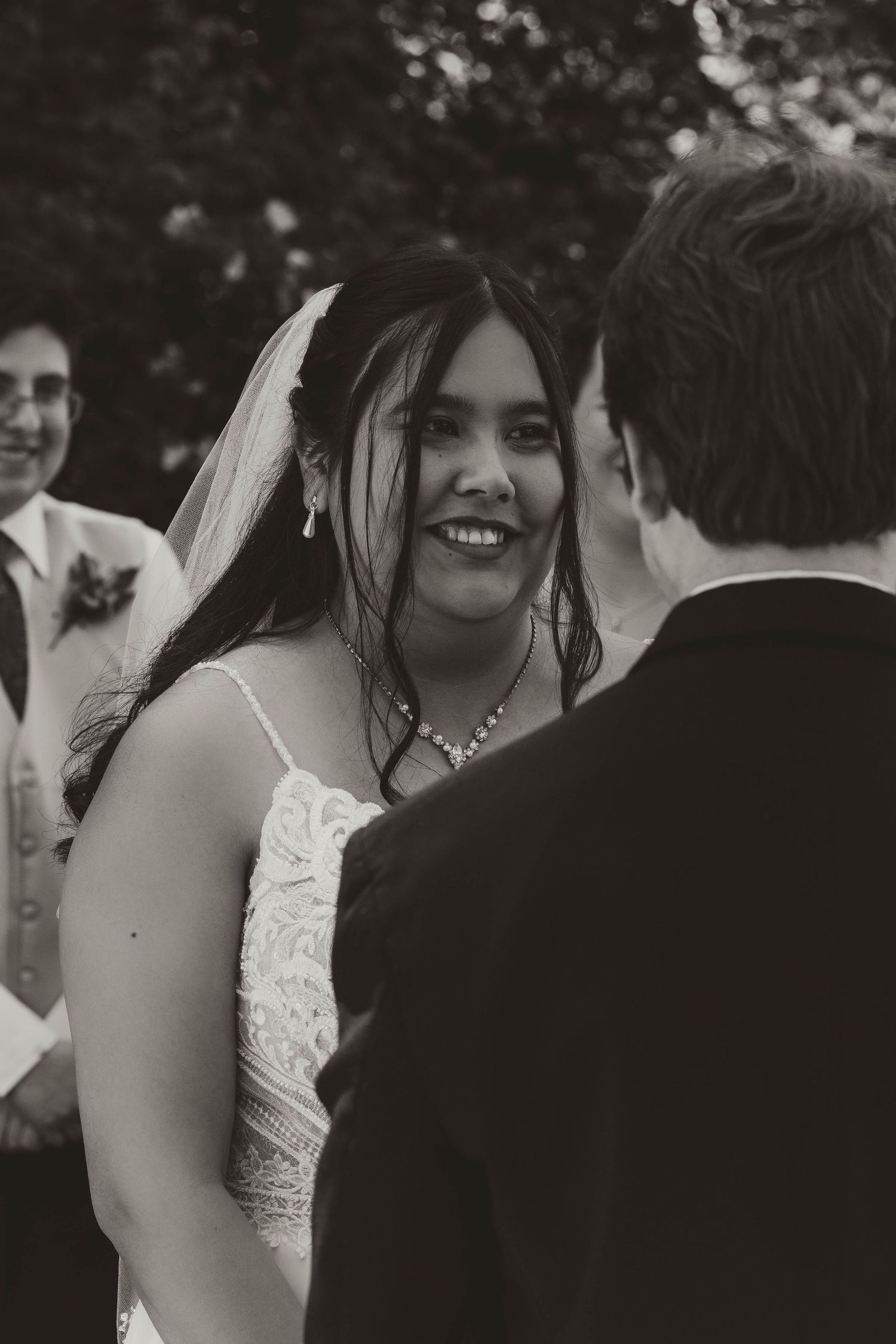 A joyful wedding ceremony moment captured in black and white showing expressions of happiness.