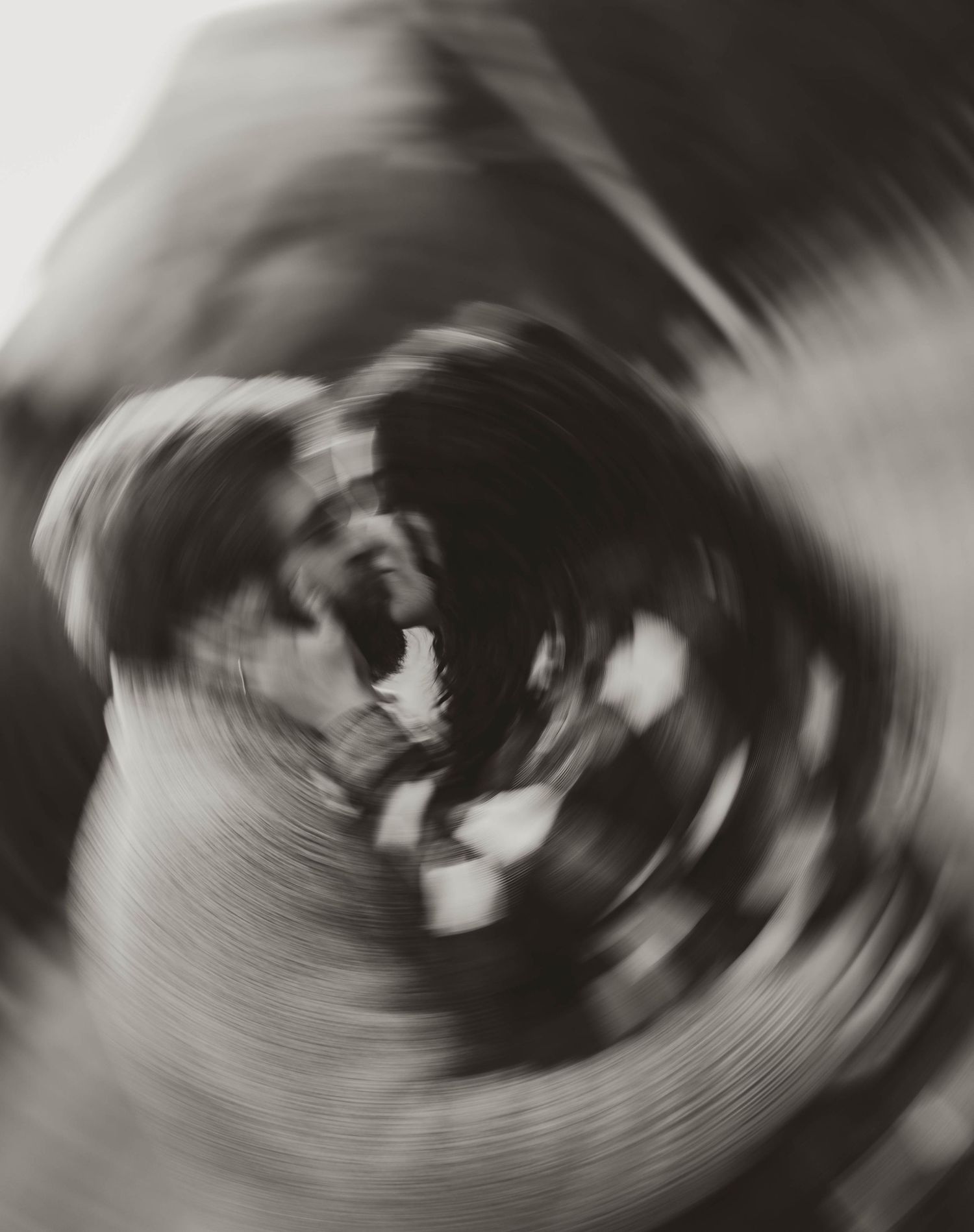 Abstract black and white spiral motion blur creating a dynamic swirling effect.
