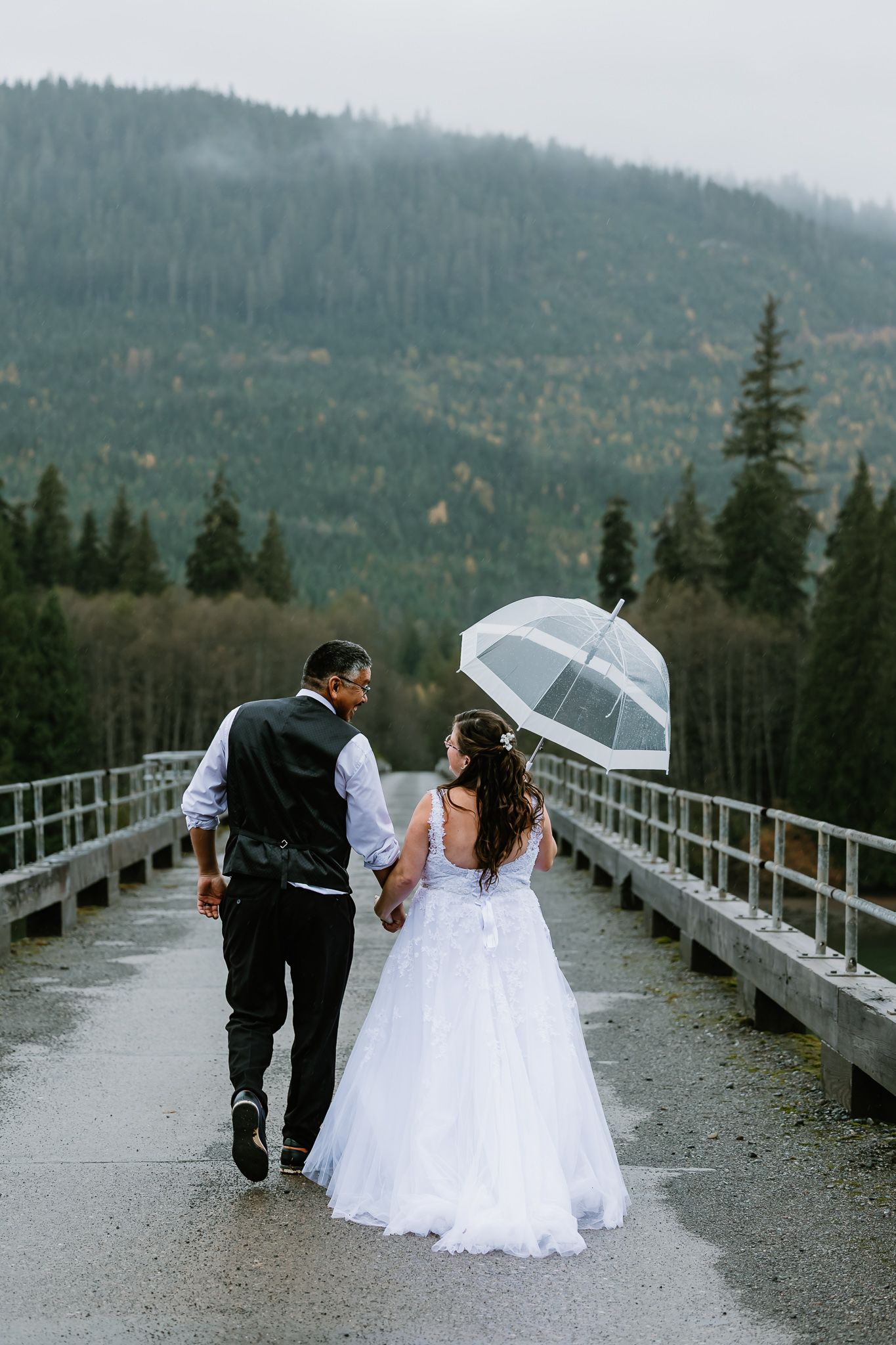 A series of wedding photos showing a couple walking along a mountain bridge with scenic forest views in the background.