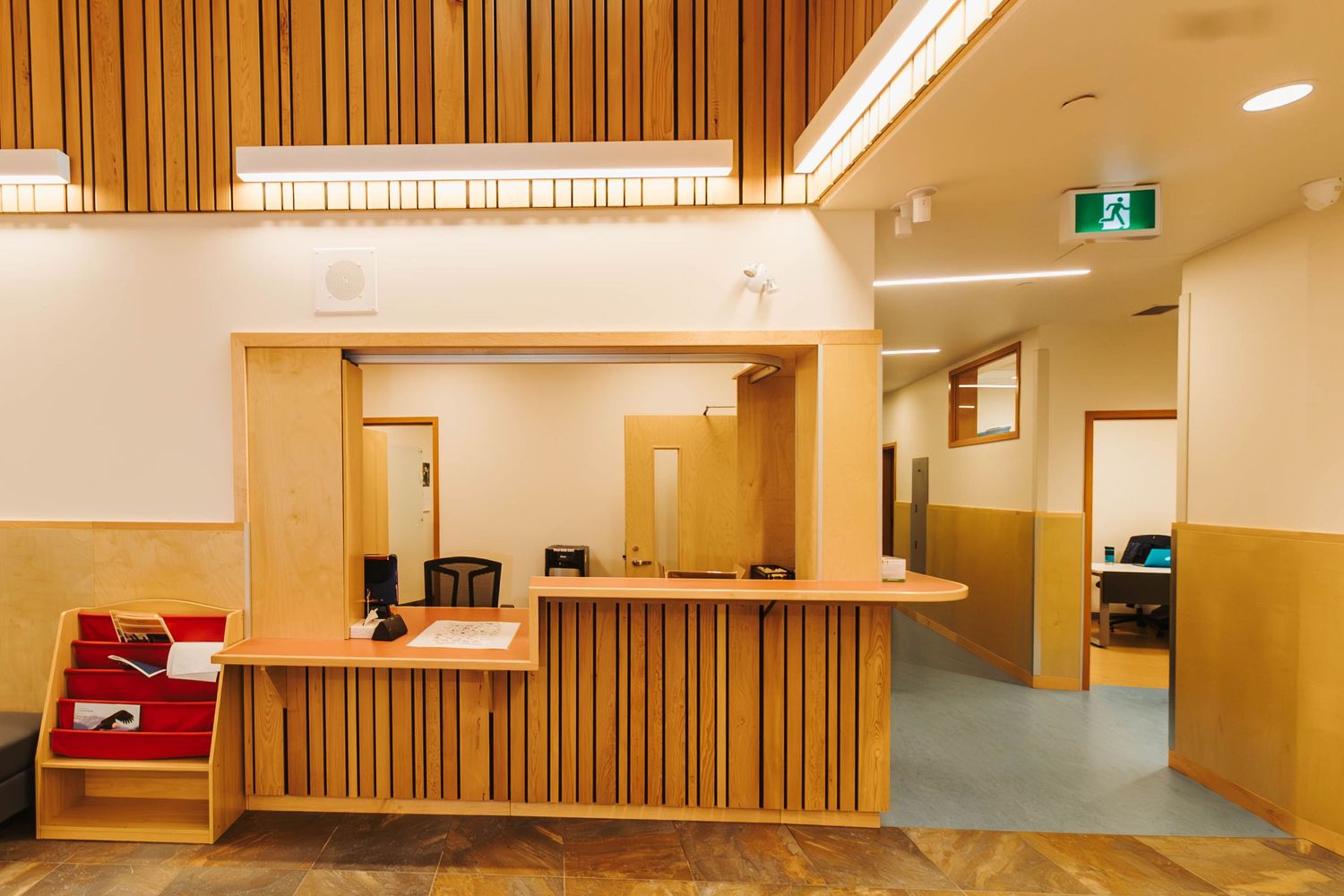 Reception area with wooden wall panels and modern design elements.
