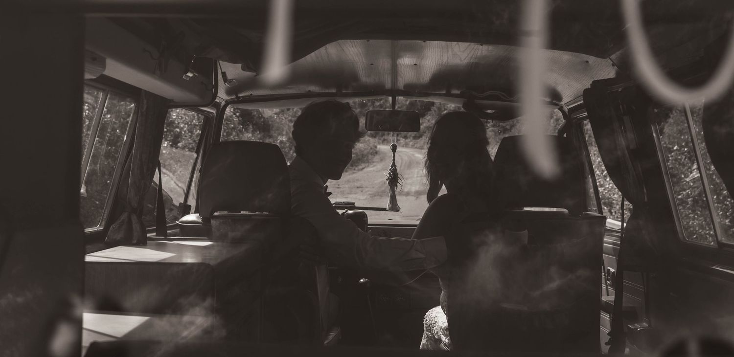 Black and white photo showing silhouettes inside a van interior.