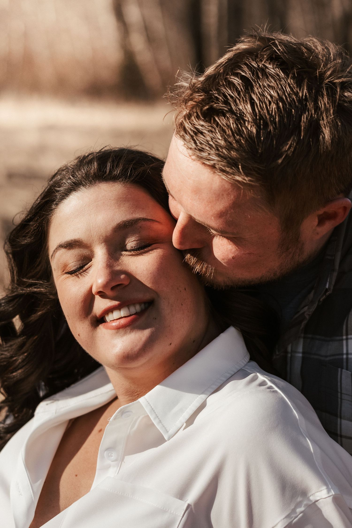 An intimate close-up portrait showing affection with warm sunset lighting.